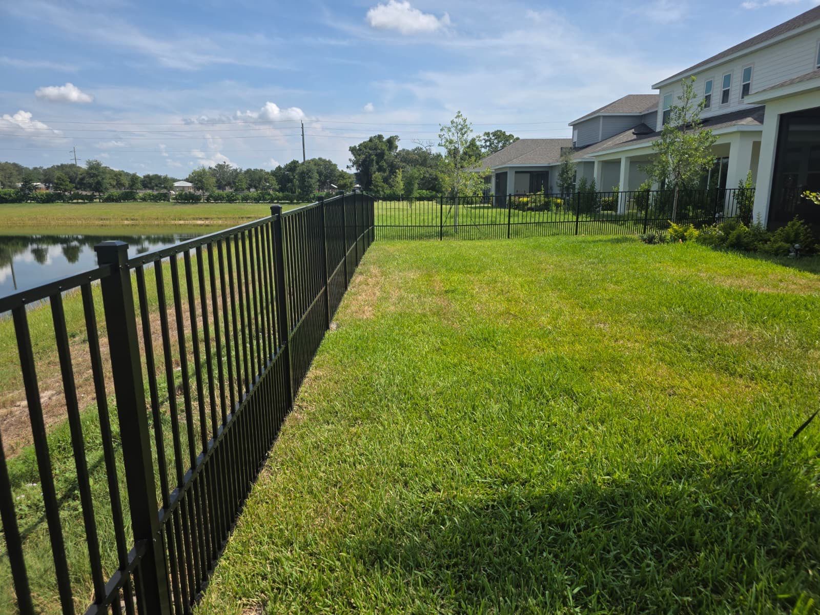 Black Aluminum Puppy Picket Fence Installation in Nokomis by True Fence LLC