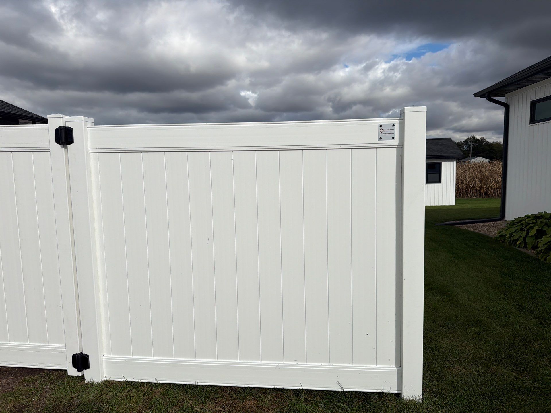 Residential White Vinyl Privacy Fence Installation in Janesville by Perfect Picket Fence and Stain