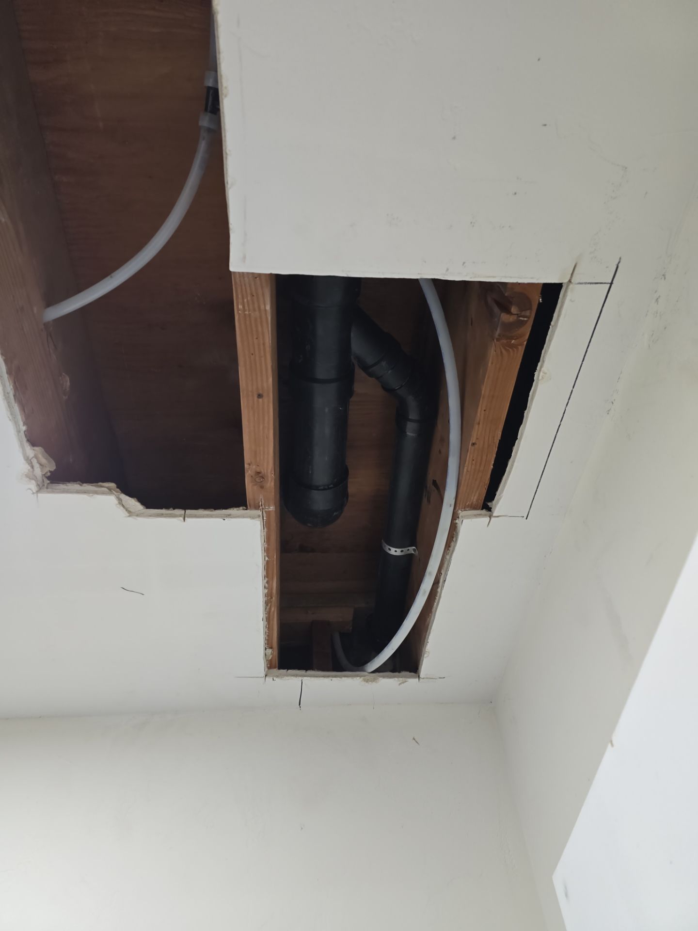Installation of New Tall Black Piping (Wall to Ceiling) & Underground Piping by Us Plumbing