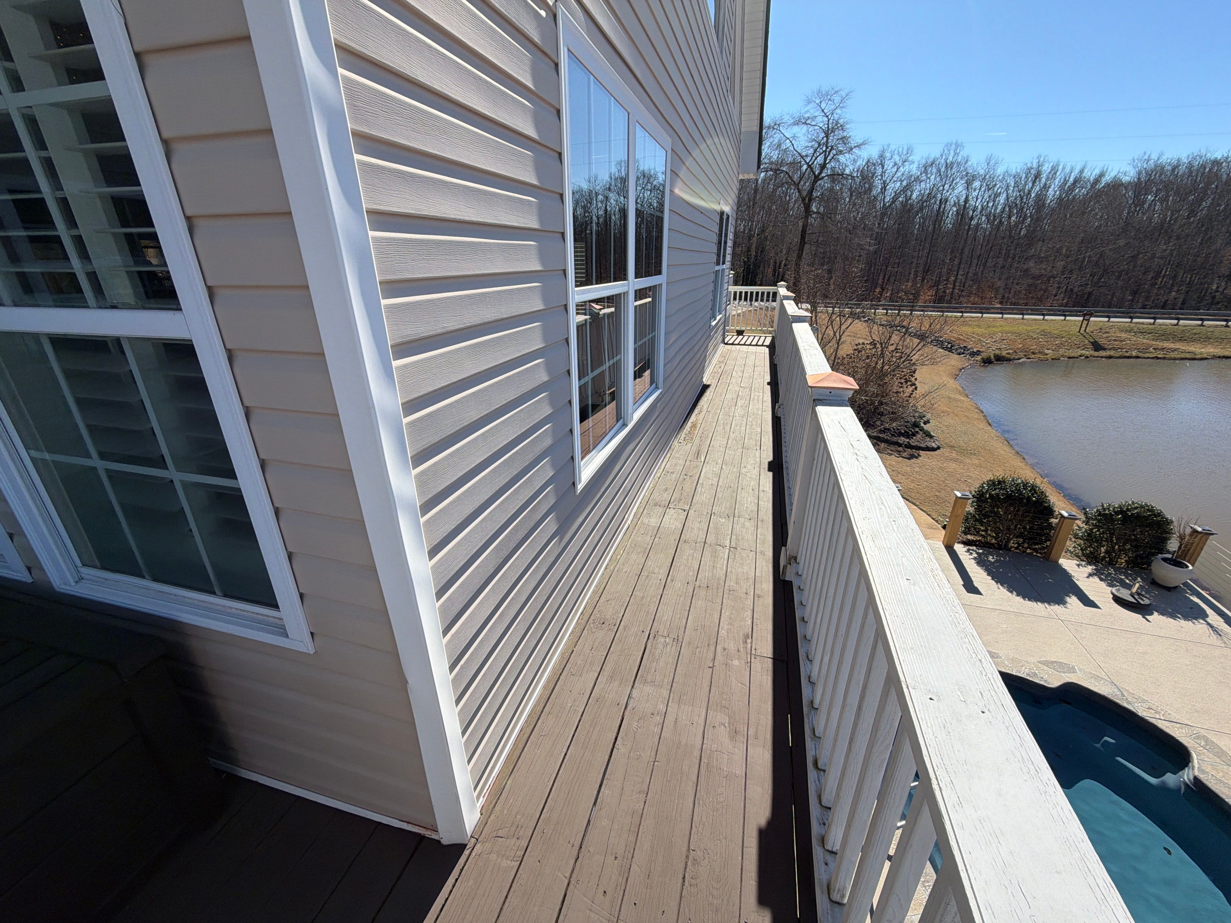 Cumming, GA Lake House Deck Resurface and Extension using Pressure Treated Pine and Skyline Cable Railing by Nelson Exteriors 