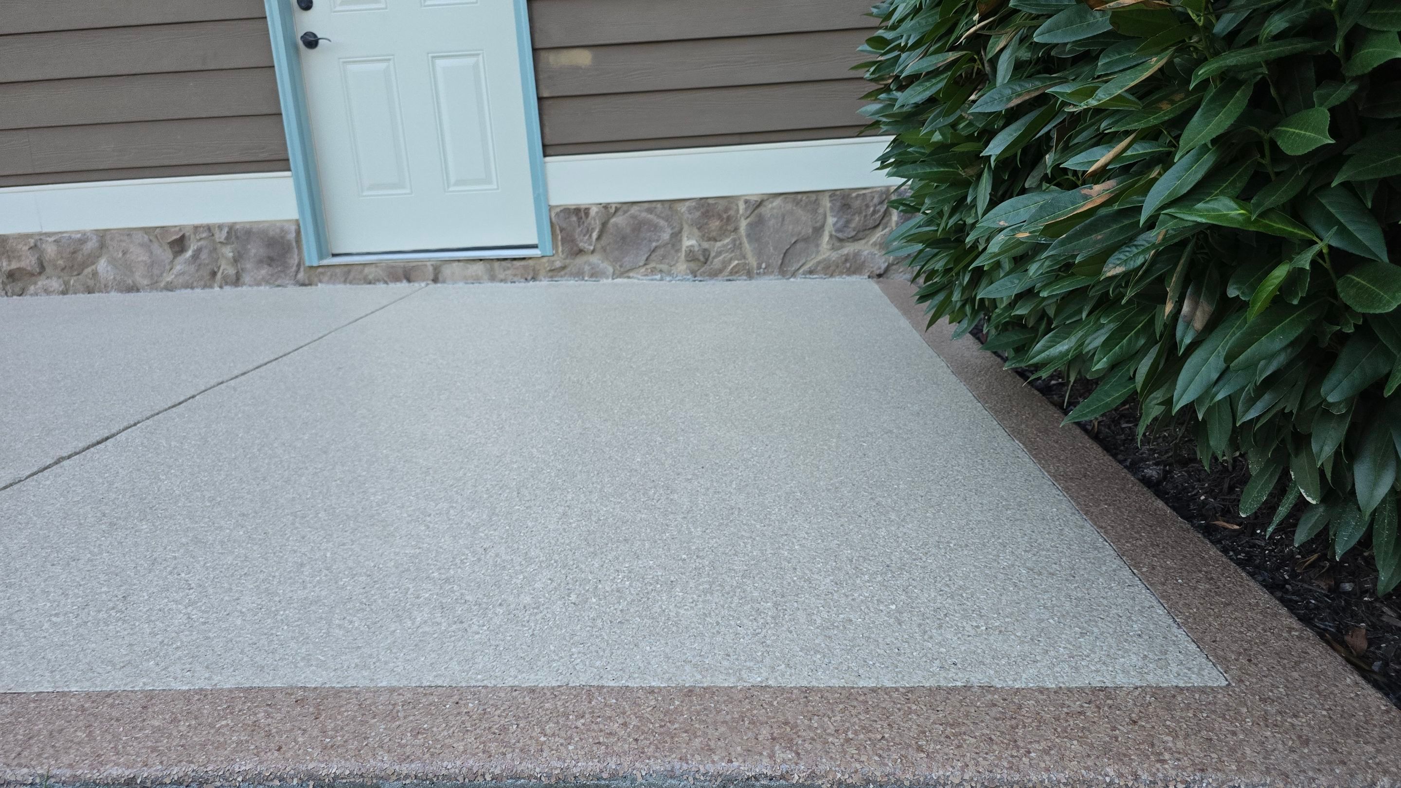 Driveway and sidewalk using Feldspar with the border done in Spilite by Elite Floor Solutions