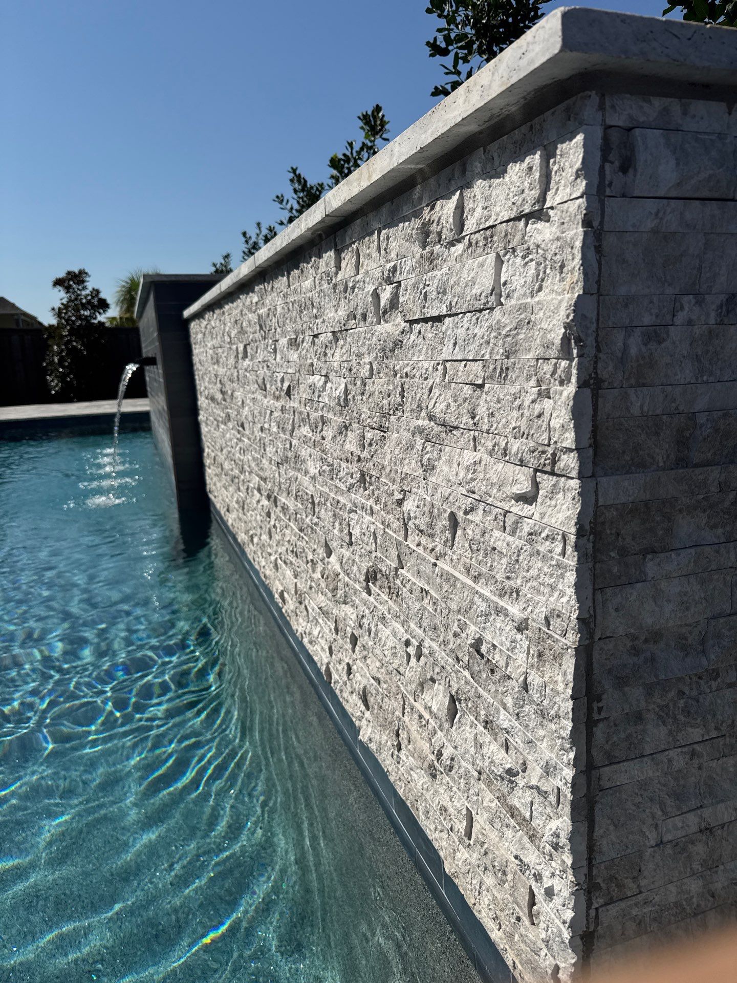 Geometric Pool with Raised Stone Scupper Wall and Outdoor Kitchen by Pinnacle Pools and Spas - DFW