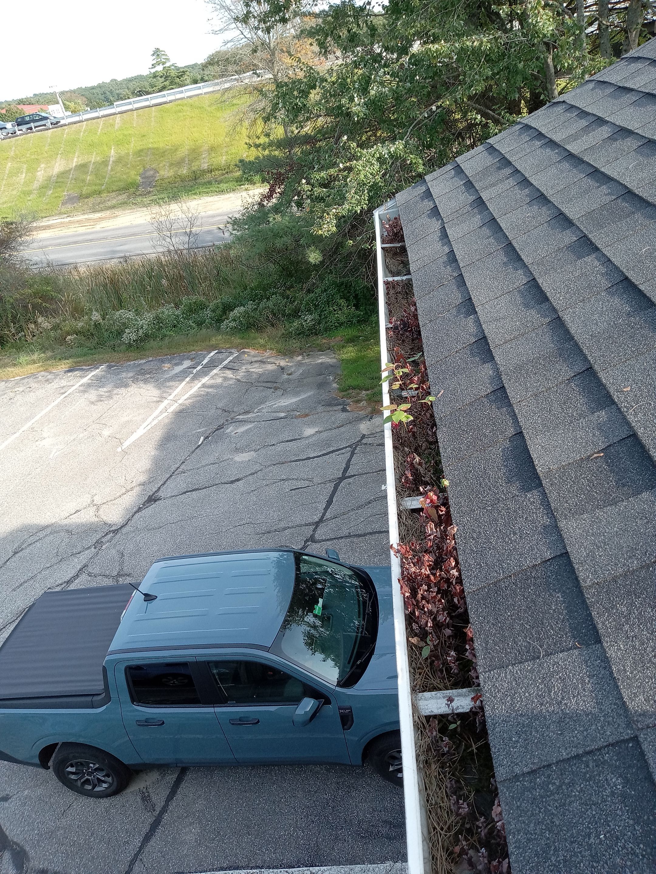 Commercial gutter cleaning Portland, ME before photo with filled gutters