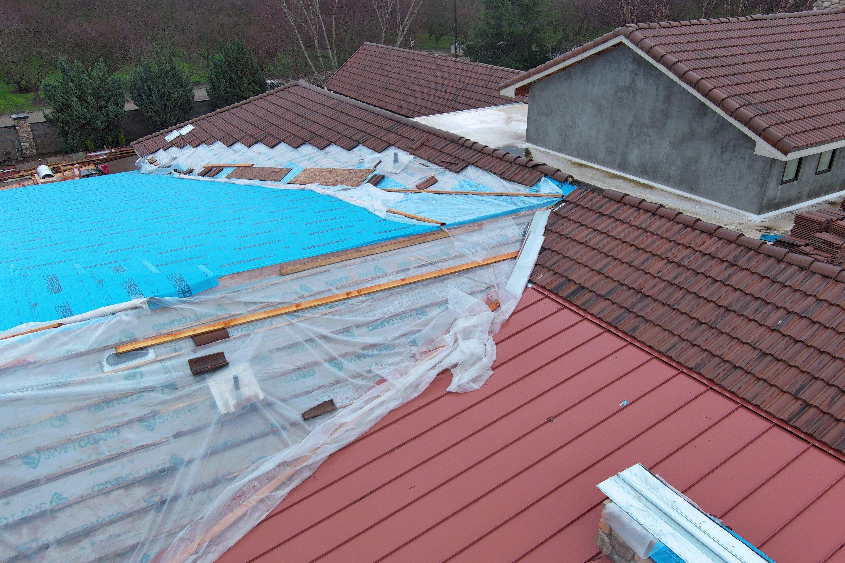 Tile, Metal, and TPO roofing project (new construction) by Straight Edge Roofing Inc