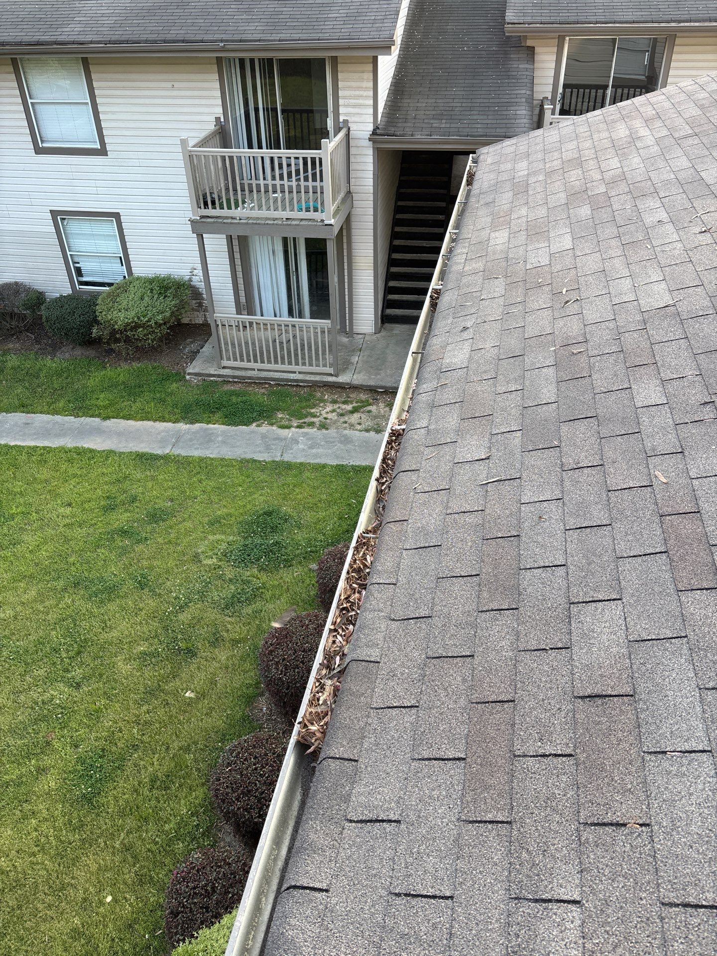 HOA gutter cleaning in Peachtree City, GA,before  photo showing full gutters.