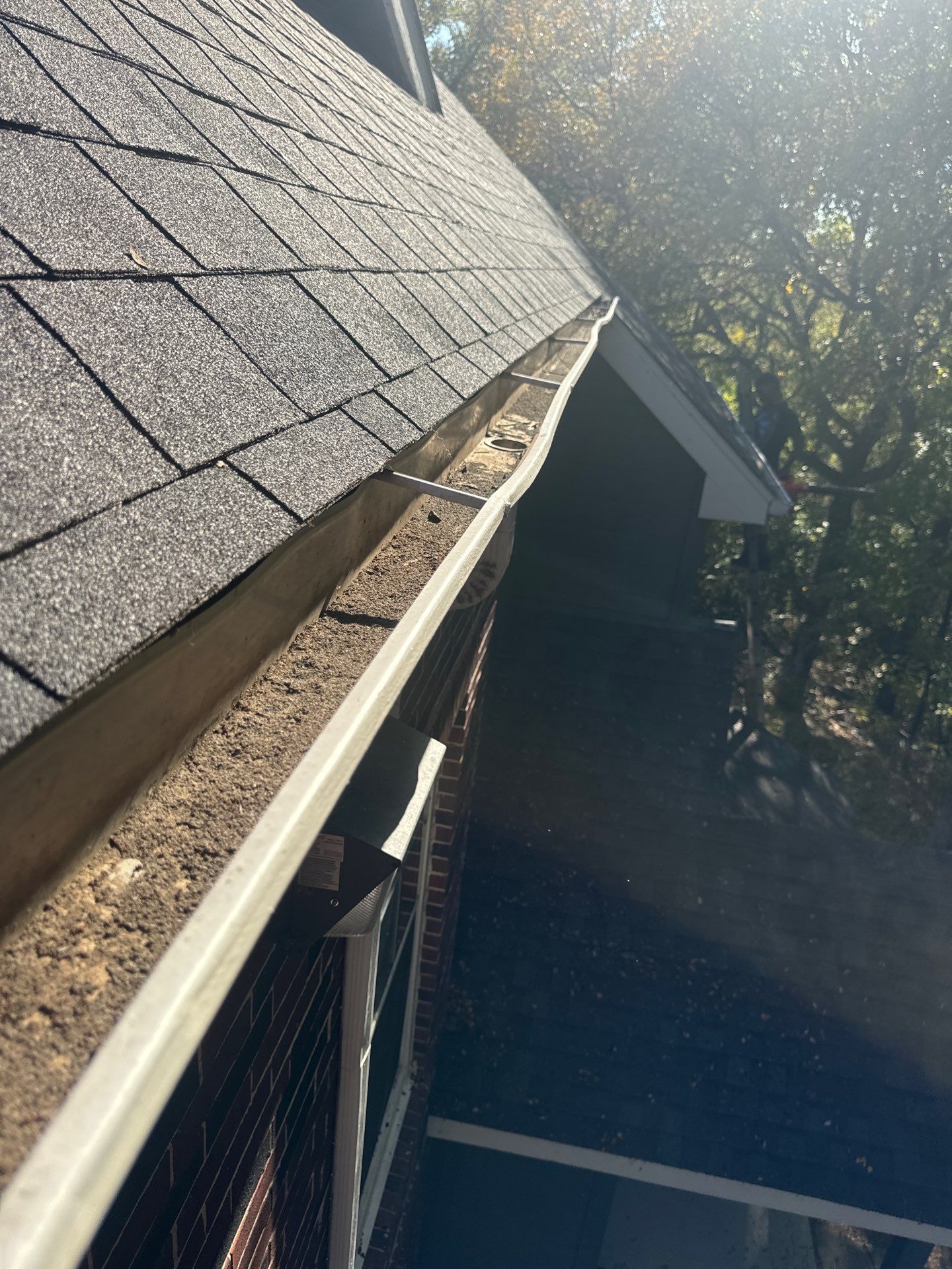 HOA gutter cleaning in Flower Mound & Lewisville, after  photo showing full gutters.