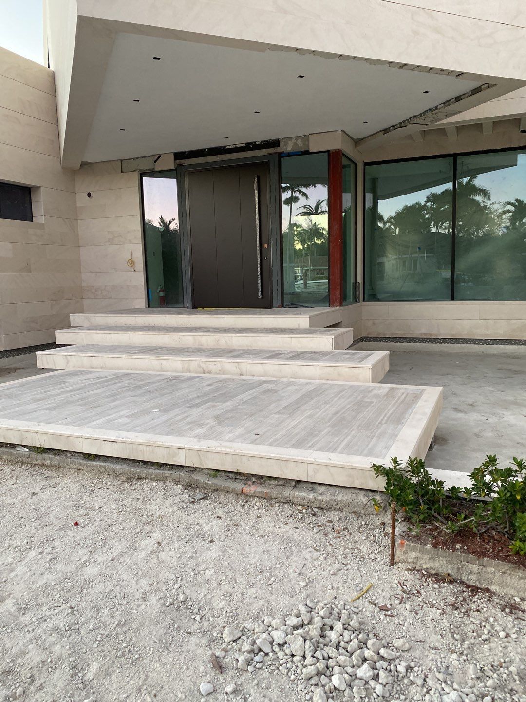 Custom Material Pivot Door installation by Impact Precious Wood Inc.