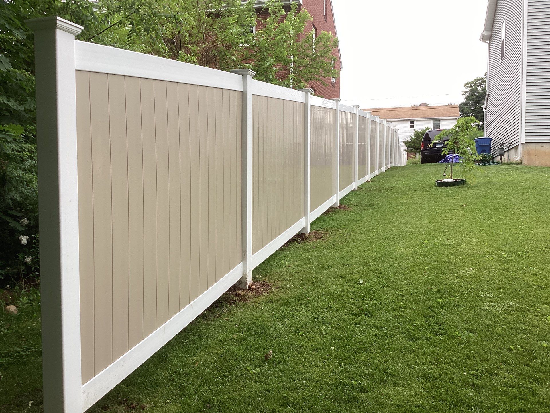 New two tone White and Clay Vinyl privacy fence. by DiGiorgi Roofing and Siding Inc