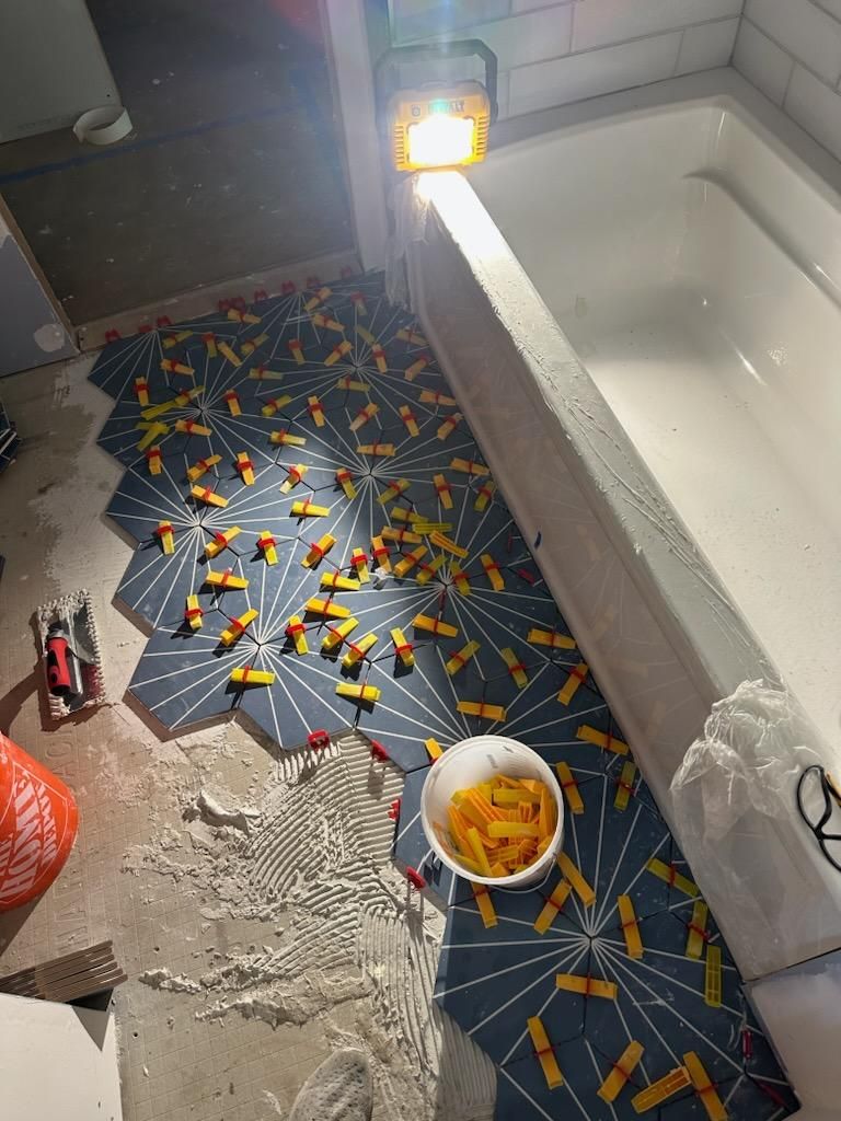 Jack & Jill Bathroom Floor + Dog Washing Nook with Niche using Porceline Subway Tile by Footprints Floors Morristown