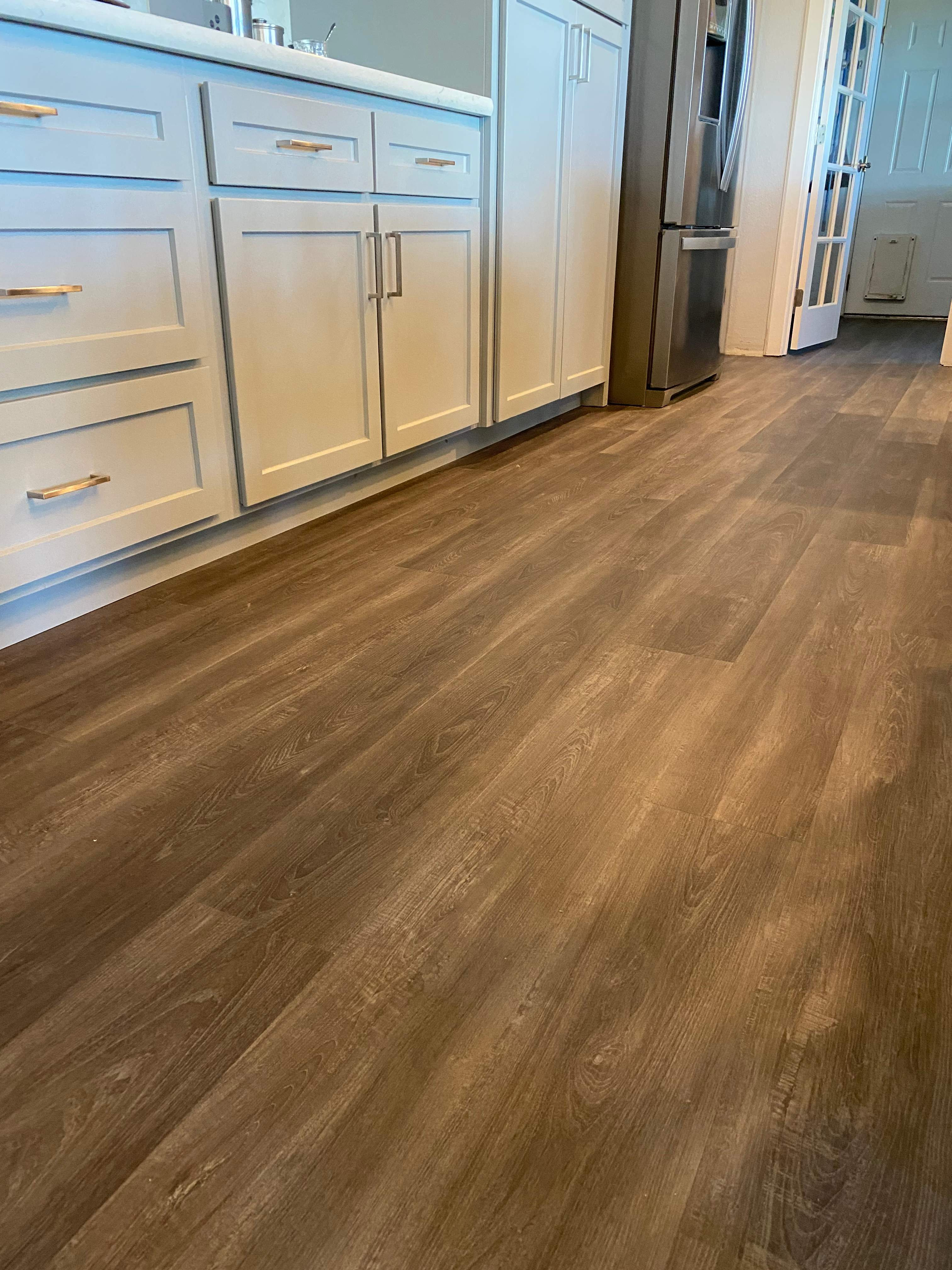 LVP Flooring for newly remodeled kitchen in Newcastle. by Footprints Floors South Sacramento