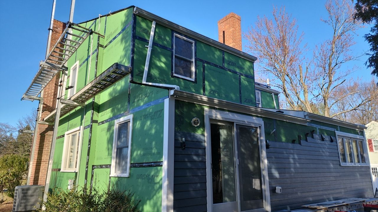 James Hardie siding, new metal roof and couple windows being installed. by UBrothers Construction