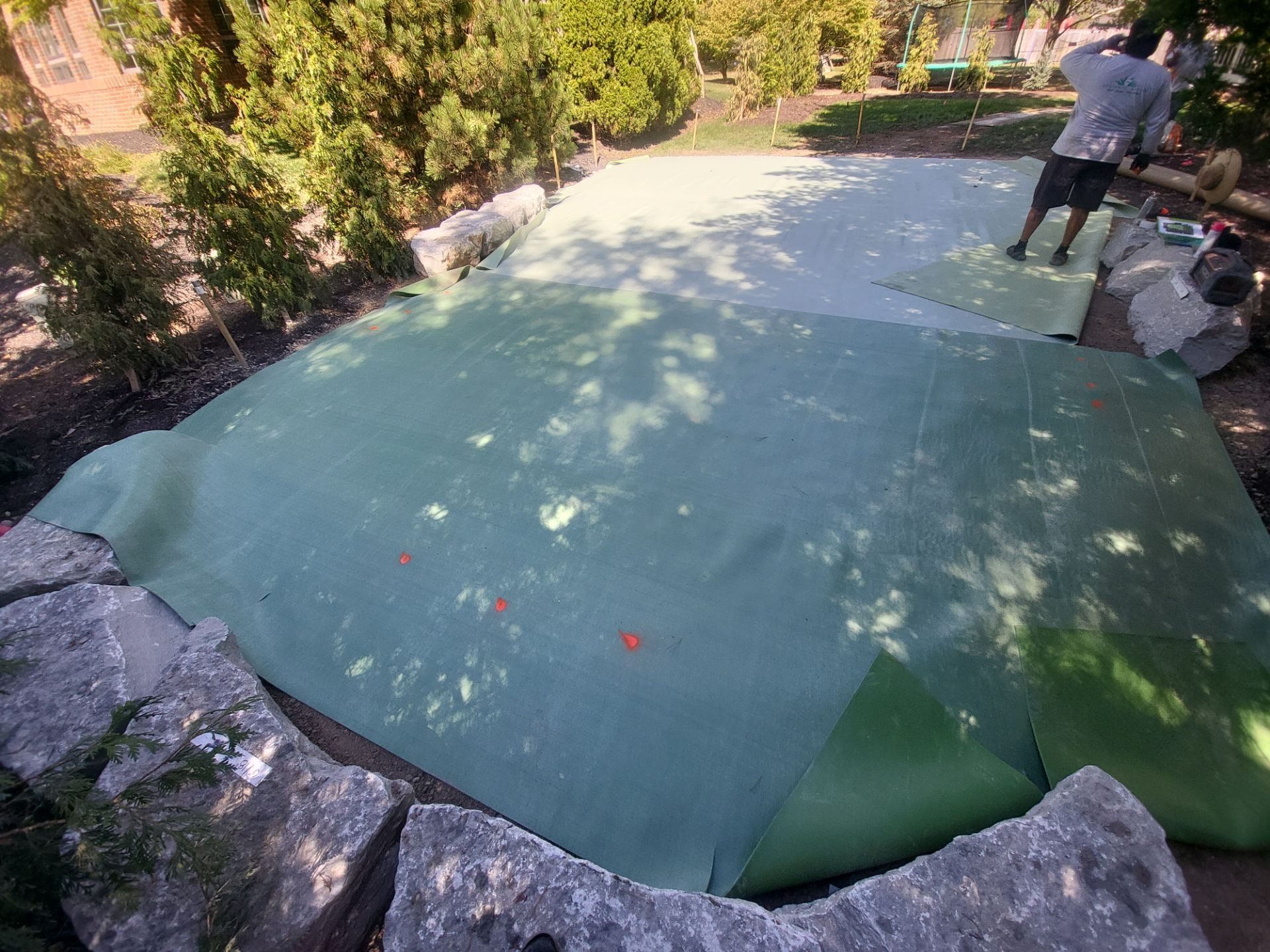 Custom Backyard Putting Green around Landscape Boulders in Hilliard by Southwest Greens Midwest