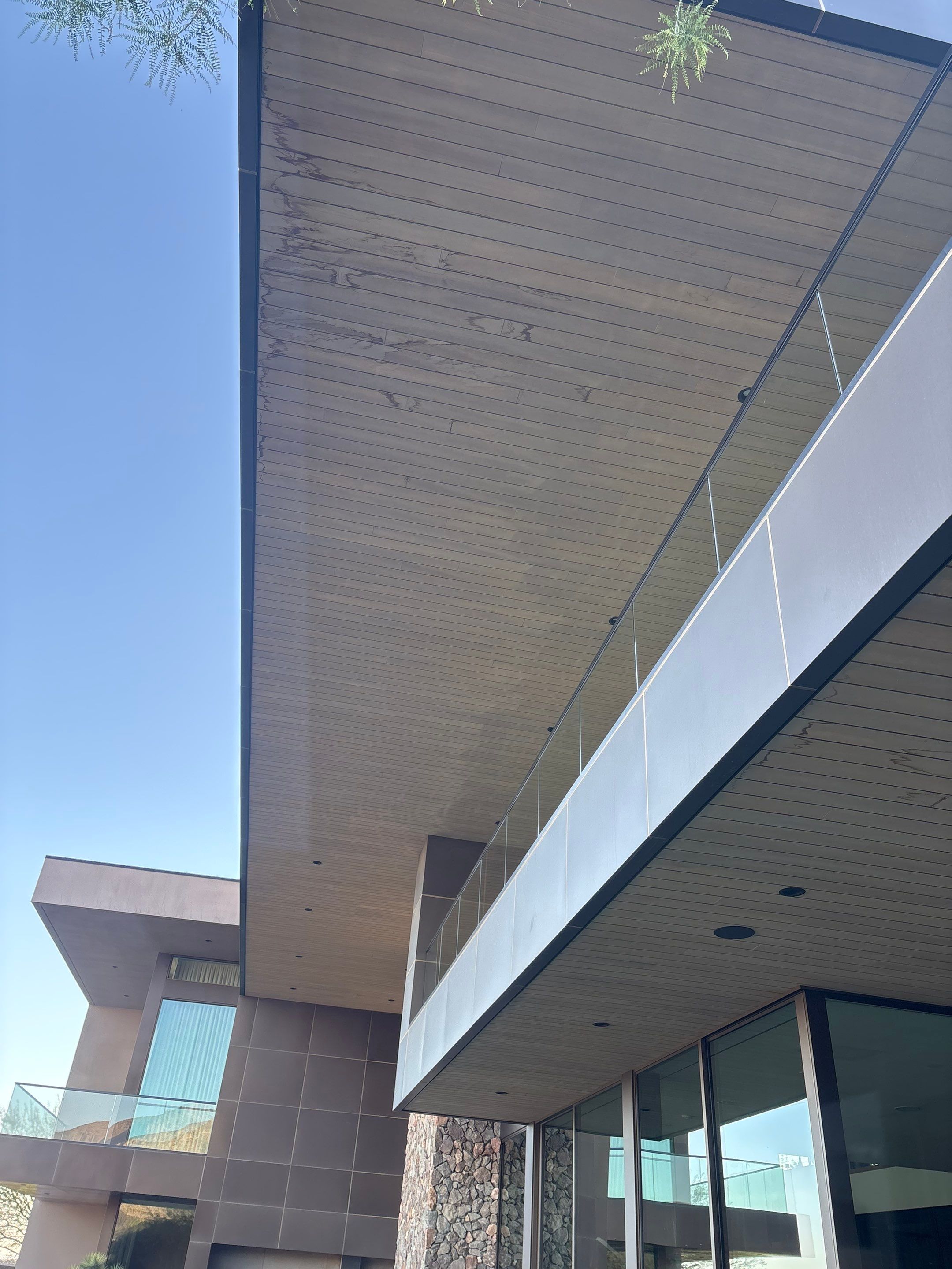 Exterior wood refinish & glass pool enclosure by Level Builders