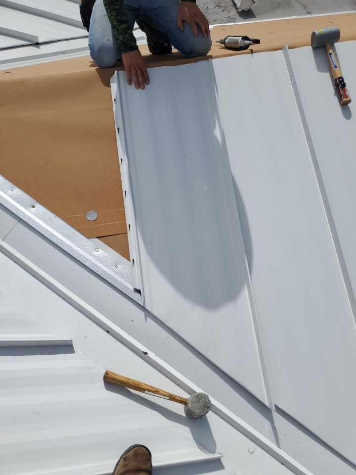 Residential Roofing Installation using 1.5" Nail Strip 24ga Solar White Kynar Coated Standing Seam Metal Panels by Morton Roofing, Inc.