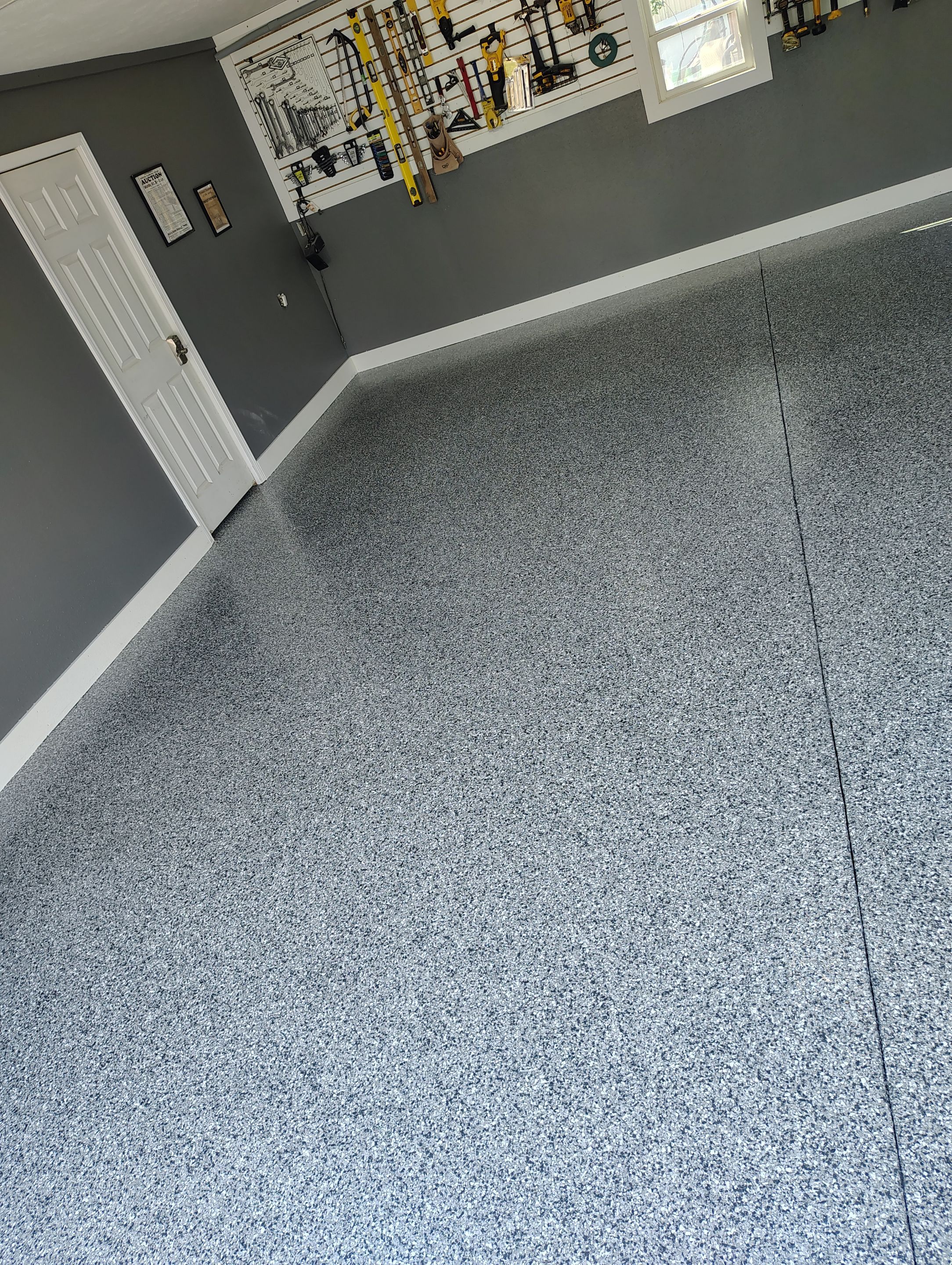 Custom Garage Floor Coating and Backyard Patio Refinishing in Tyndall by Select Painting, Coatings & Garage Cabinets