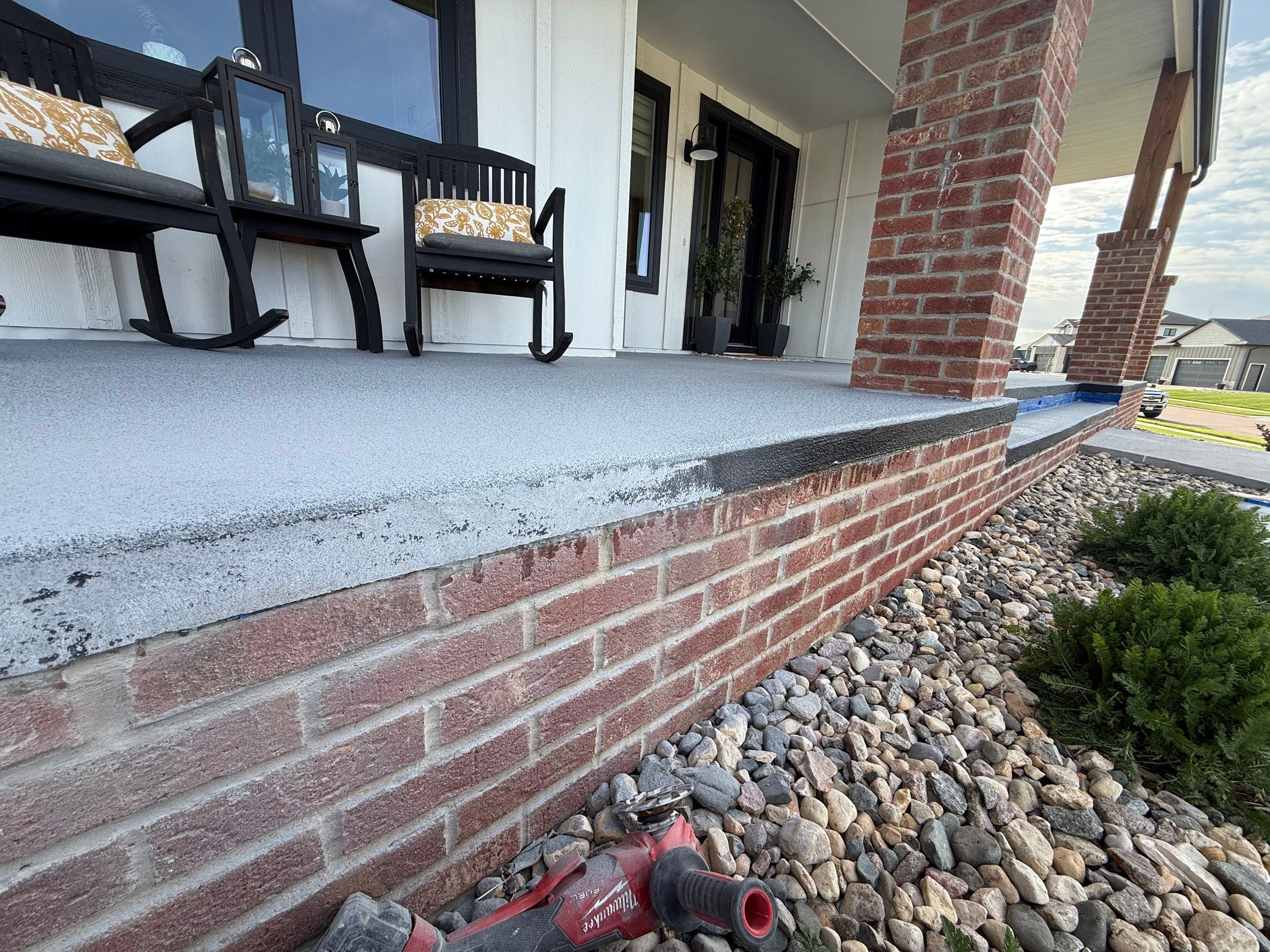 Grey Speckled Concrete Porch Coating for Sioux Falls Home by Select Painting, Coatings & Garage Cabinets