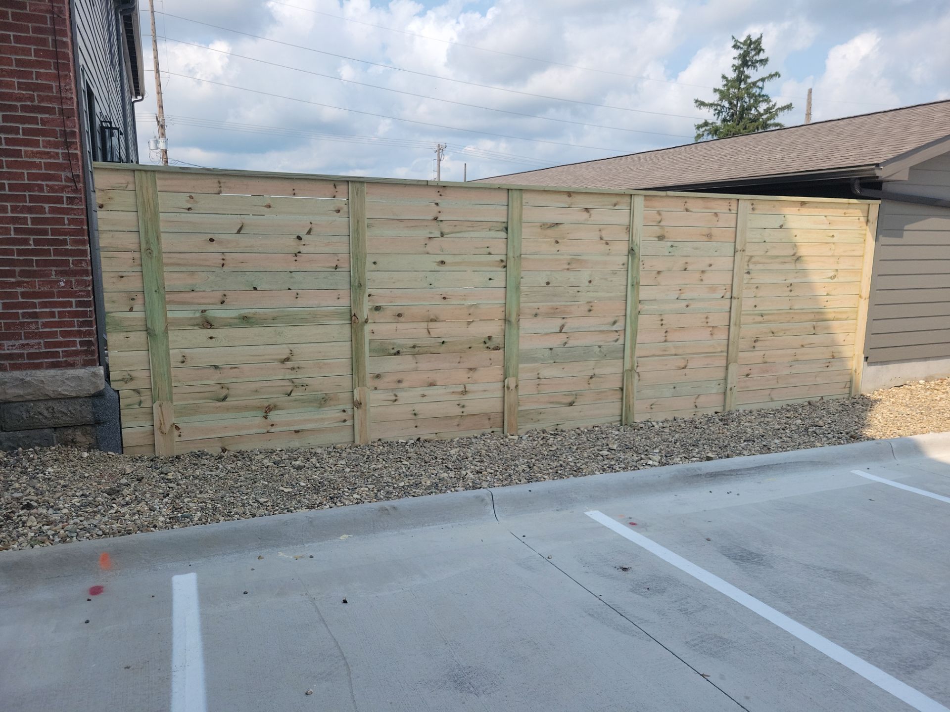 Modern Horizontal Slat Wood Privacy Fence Installation in Cedar Falls by Perfect Picket Fence and Stain