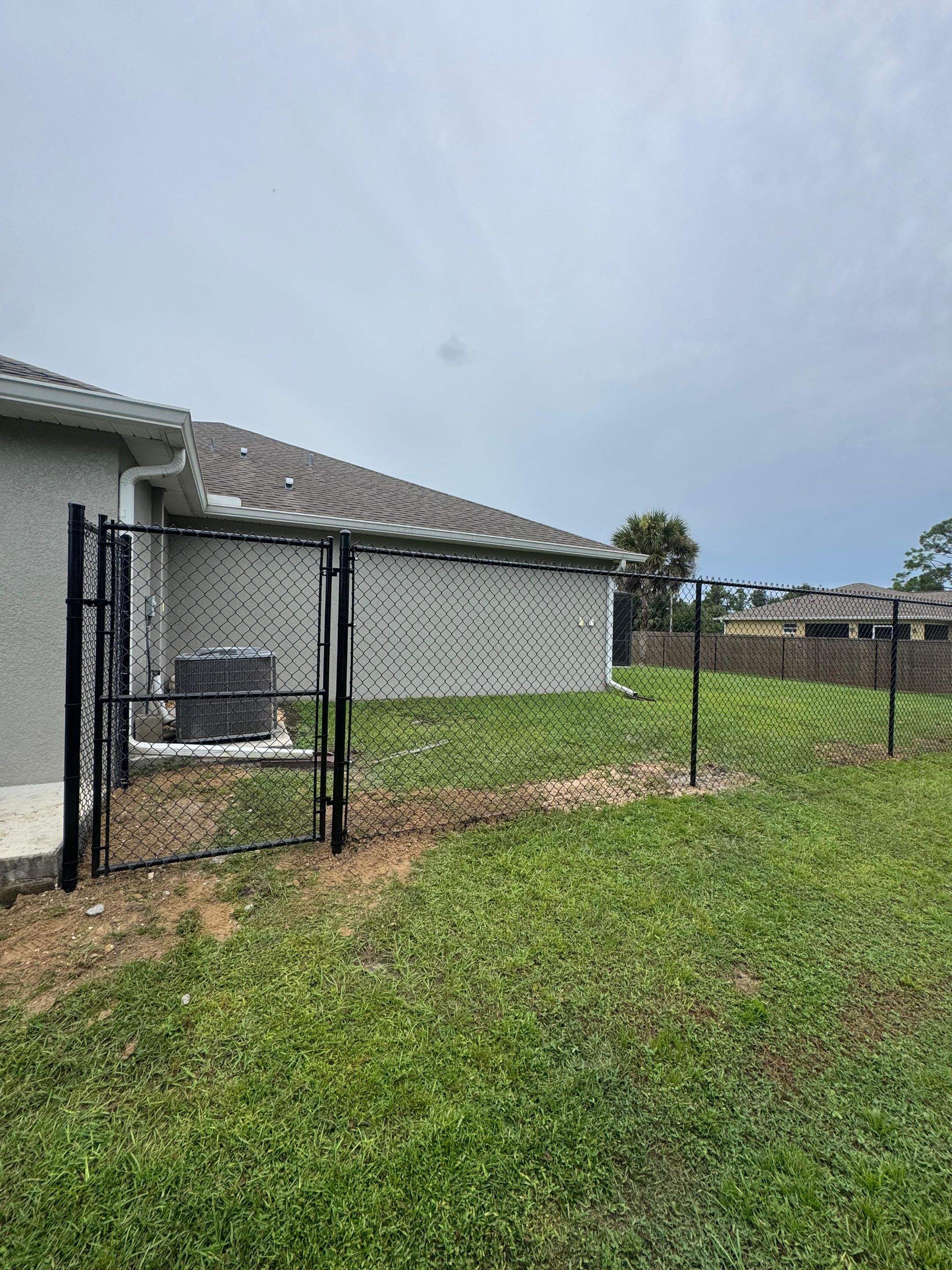 Black Chain Link Boundary Fence with Access Gates in North Port by True Fence LLC