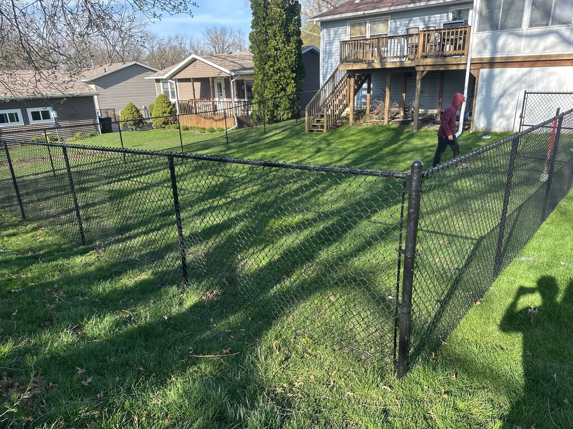 Black Vinyl-Coated Chain Link Fence Installation in Waterloo by Perfect Picket Fence and Stain