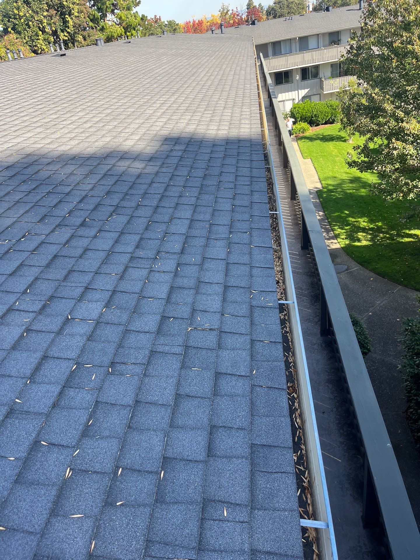Commercial gutter cleaning Lincoln, NE before photo with filled gutters