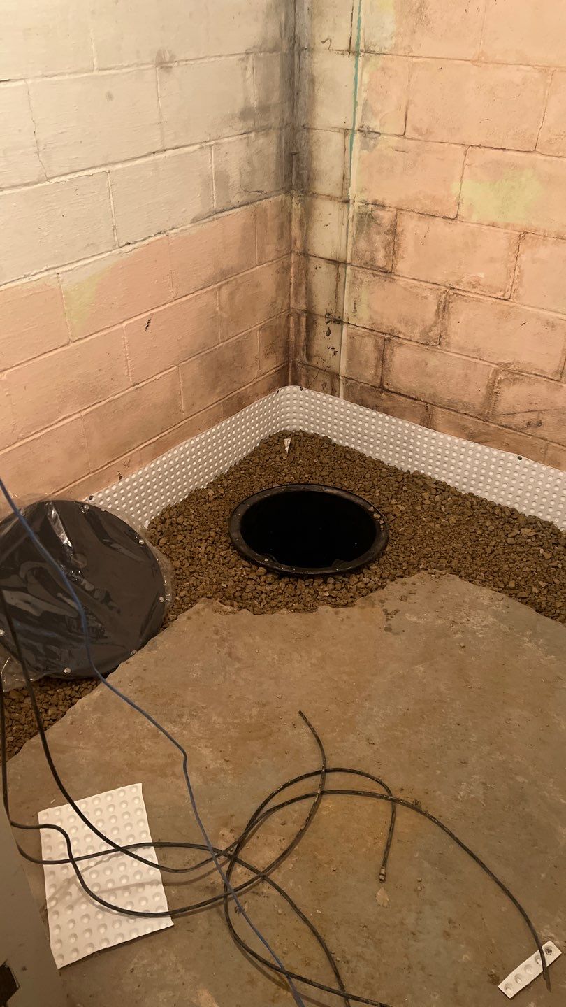 Interior drain tile system installation by ACE Waterproofing & Basement Solutions
