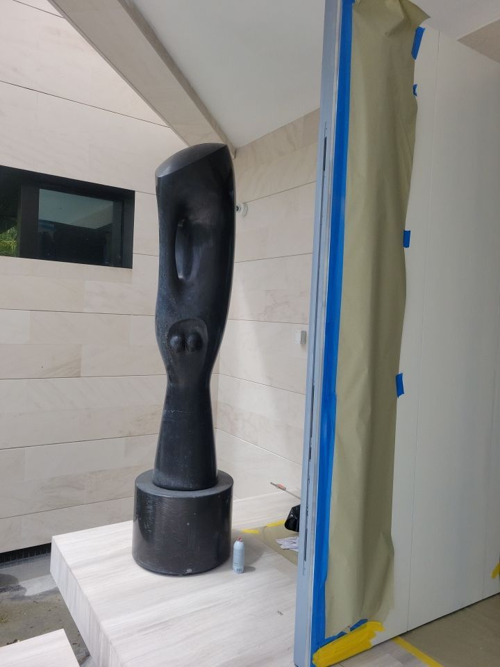 Custom Material Pivot Door installation by Impact Precious Wood Inc.