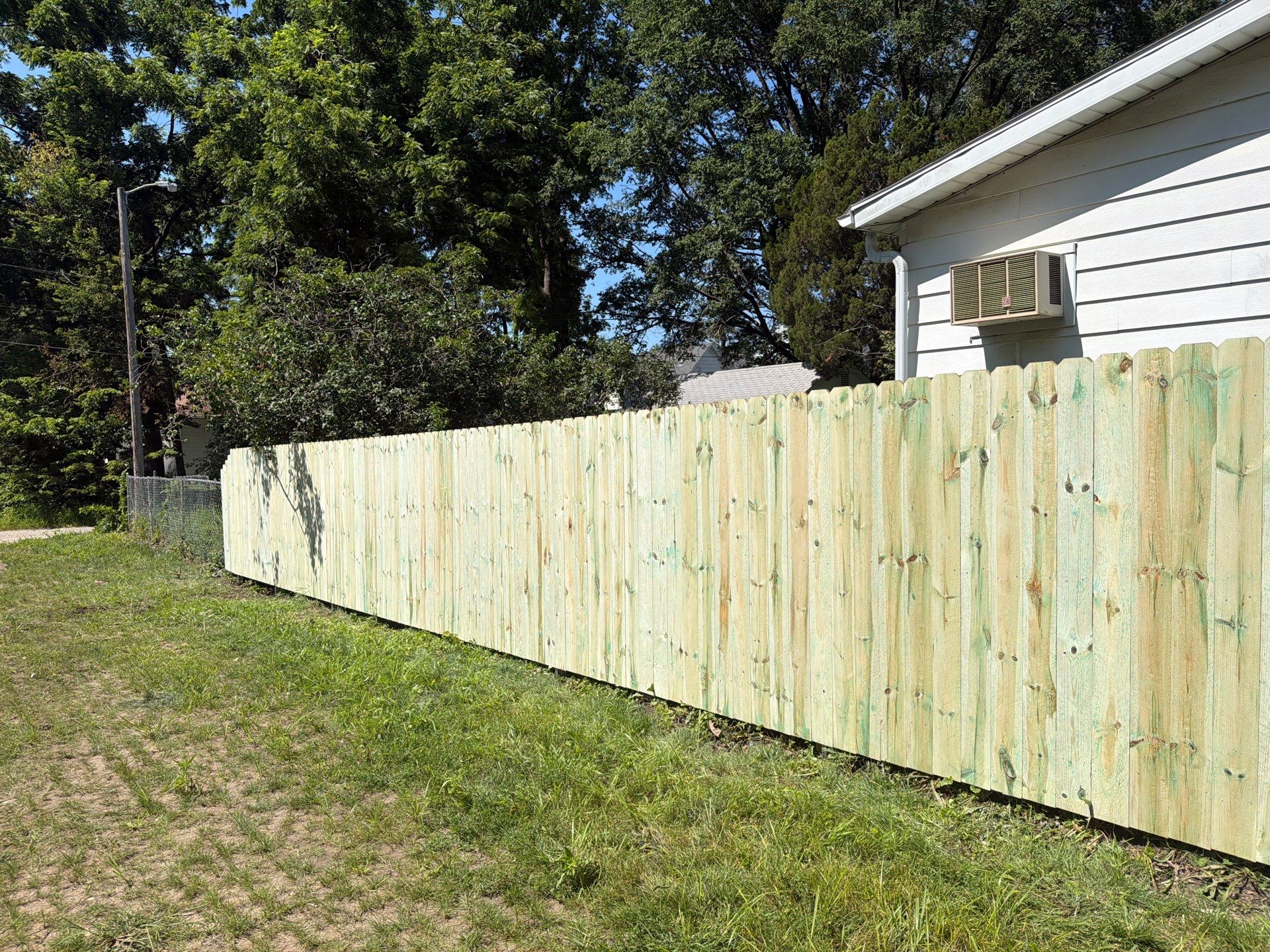 Pressure-Treated Wood Privacy Fence Installation in Waterloo by Perfect Picket Fence and Stain