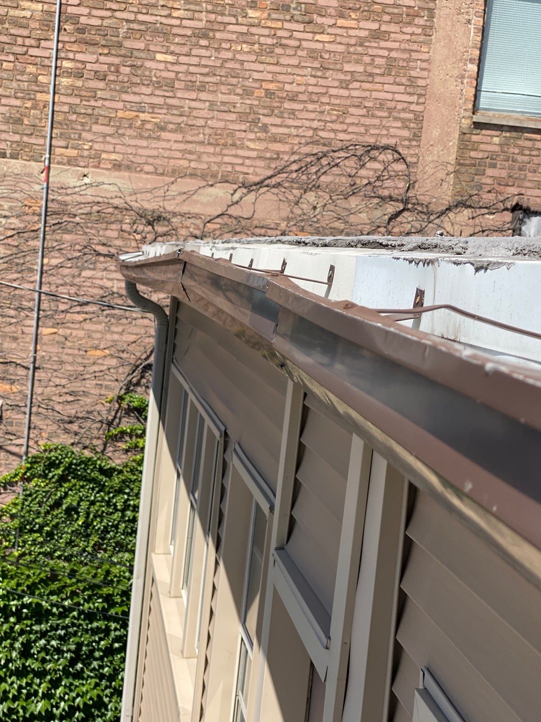 Asphalt Roof Replacement with Aluminum Gutter Installation by Custom Installations