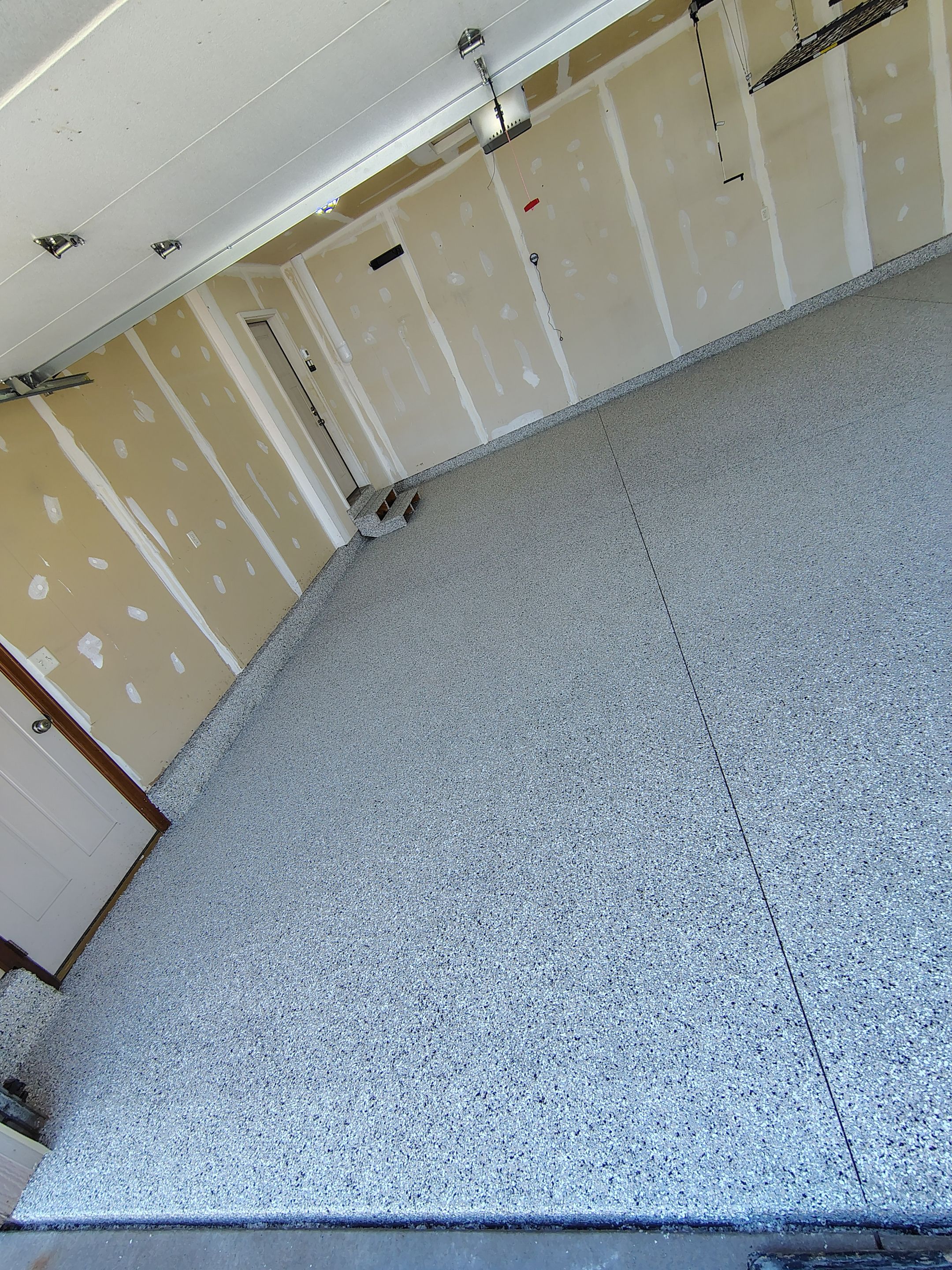 Multi-Car Garage Concrete Coating and Epoxy Finish in Sioux Falls by Select Painting, Coatings & Garage Cabinets