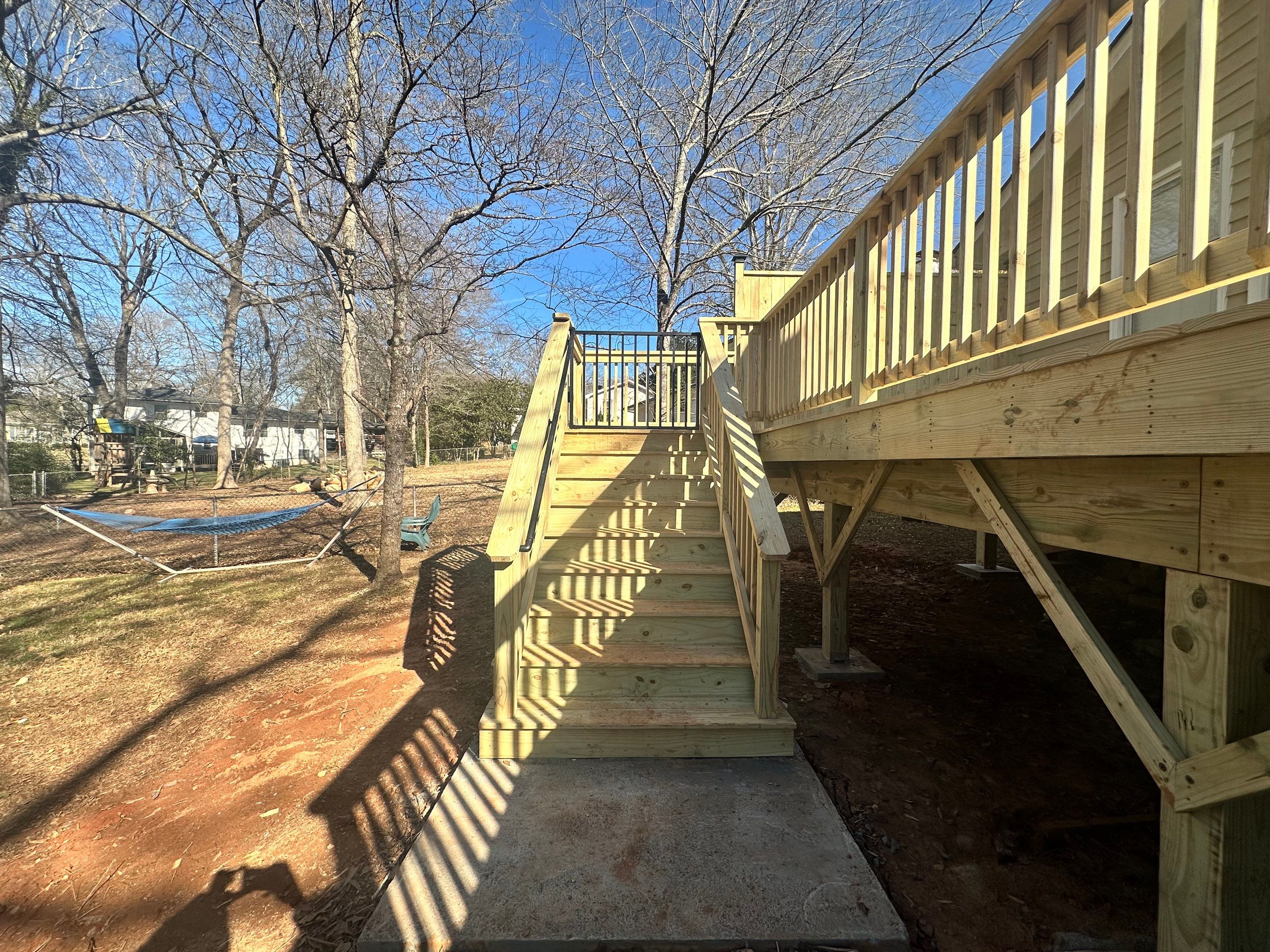 Elevated Pressure-Treated Wood Deck Extension in Marietta by Swift Home Renovations