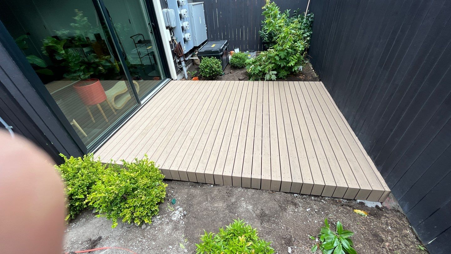 Modern Backyard Deck by Alki deck builders 