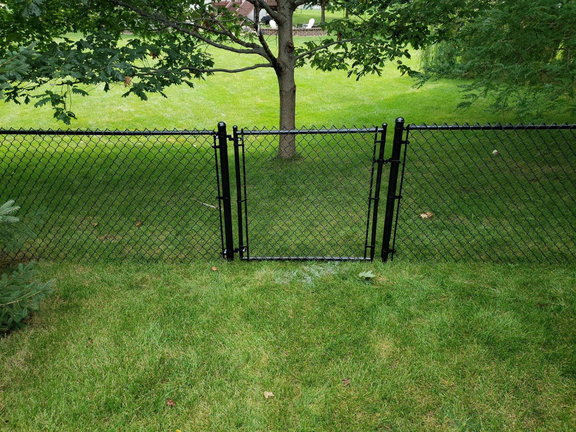 Black Vinyl-Coated Chain Link Fence Installation in Cedar Falls by Perfect Picket Fence and Stain