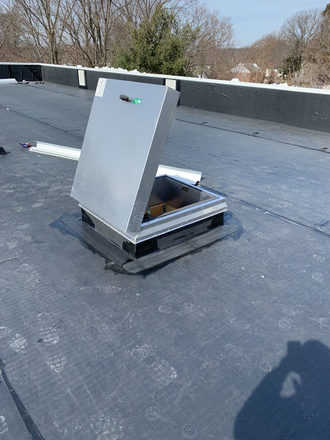 Commercial Roofing Installation using EPDM with white gutters by A Plus Exterior