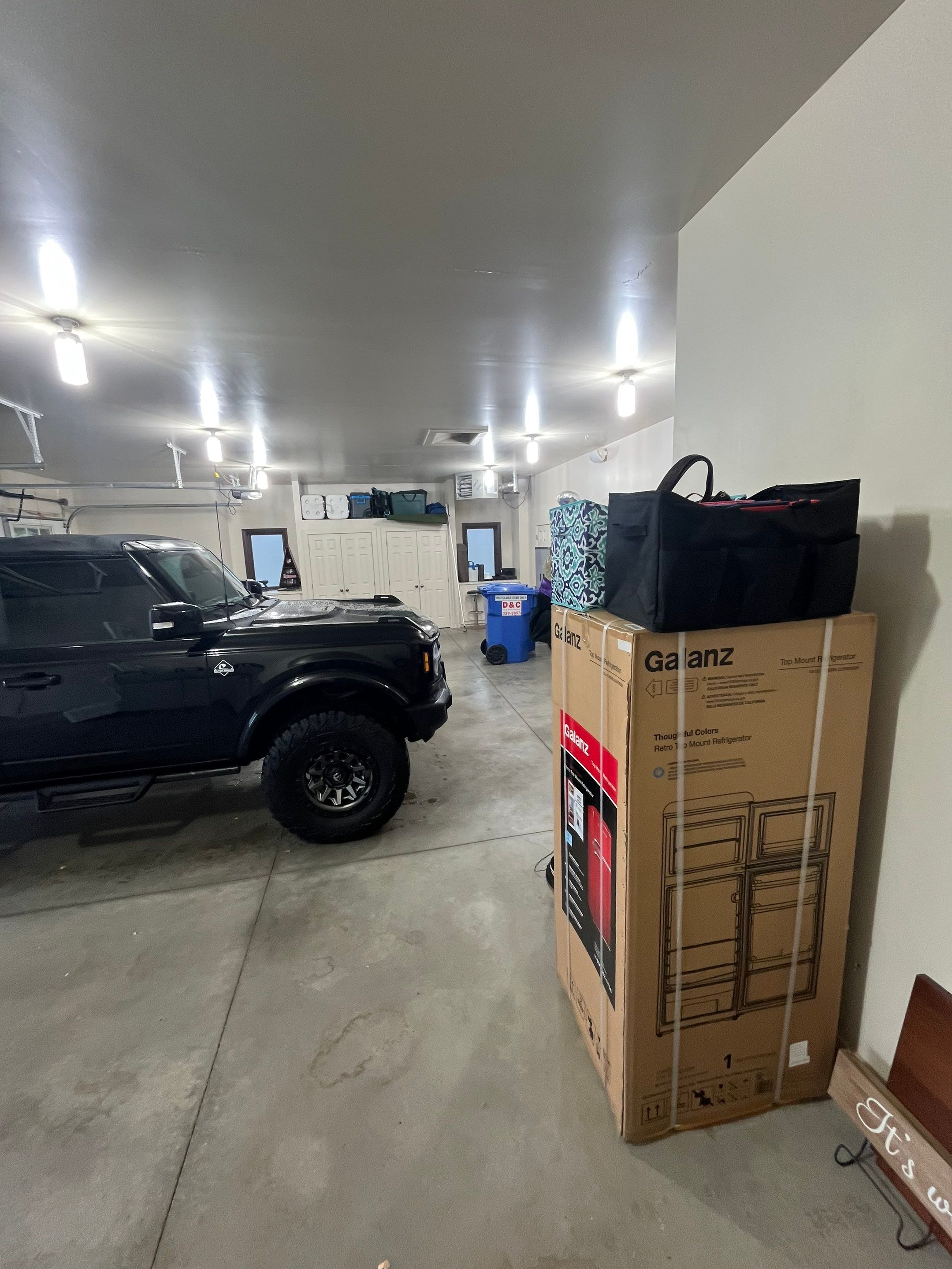 Coyote Flake Garage Floor Coating in Sioux Falls with Trench Drain by Select Painting, Coatings & Garage Cabinets