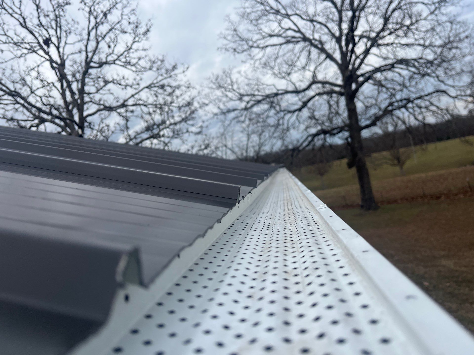 Residential Roof + Gutters & Downspouts & Gutter Covers Install  by Titan Commercial & Residential Roofing 