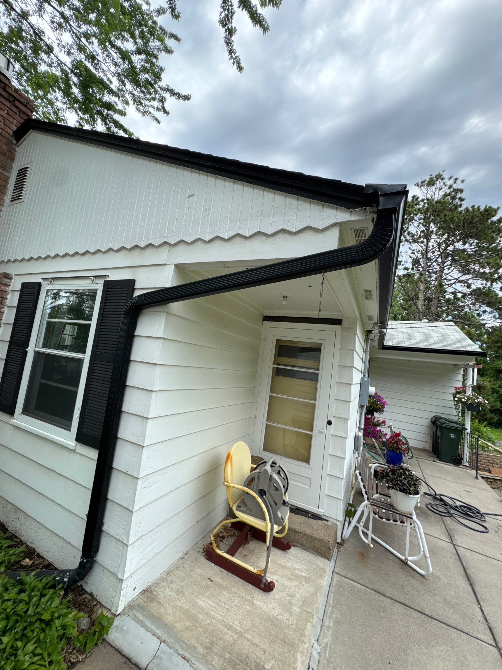 Eagan - Black Seamless Gutters with Helmet Style Guards by Forever Fortified