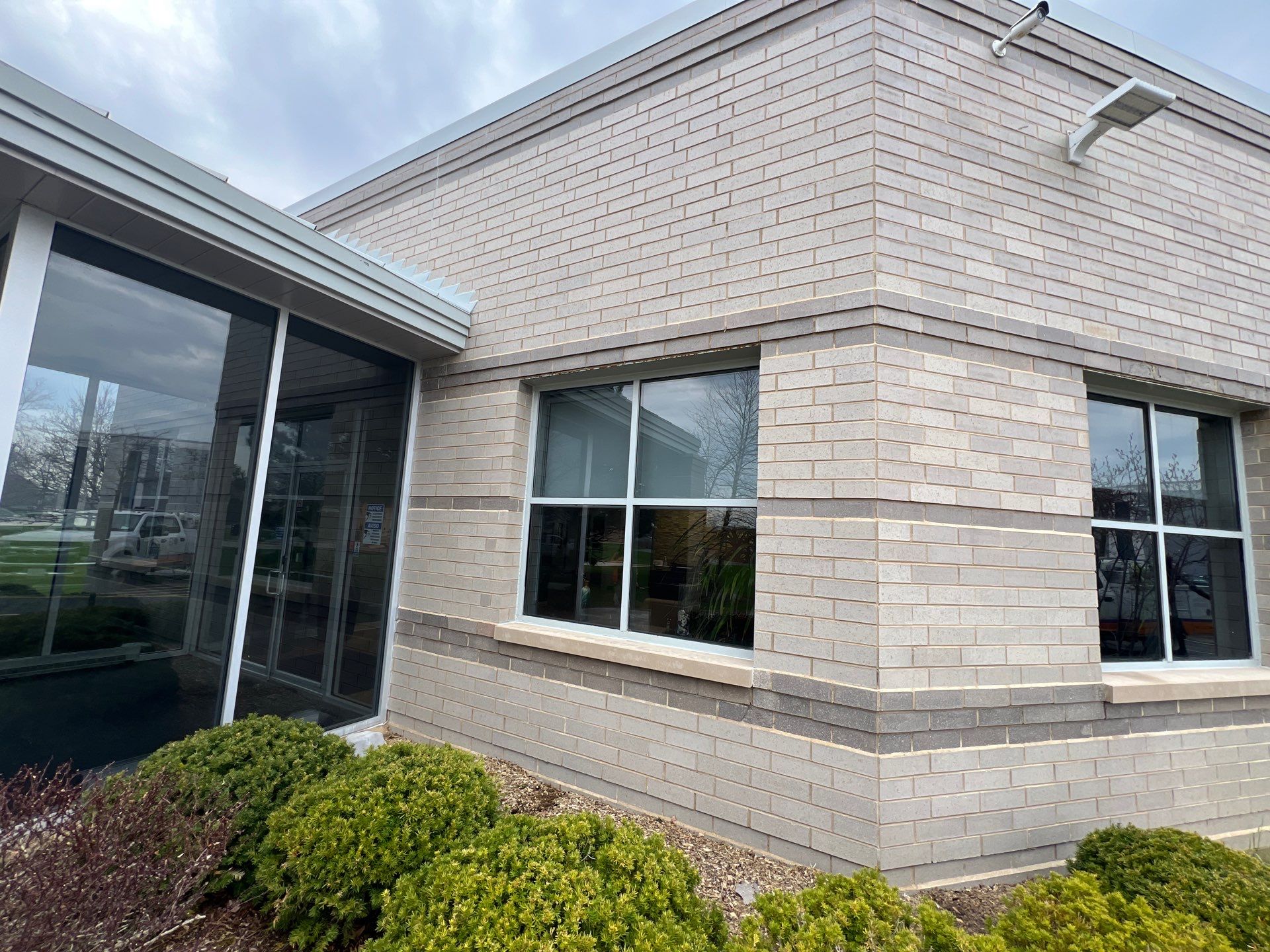 Commercial Facade cleaning using Algaecide, soft wash soap by Northern Power Washing LLC.