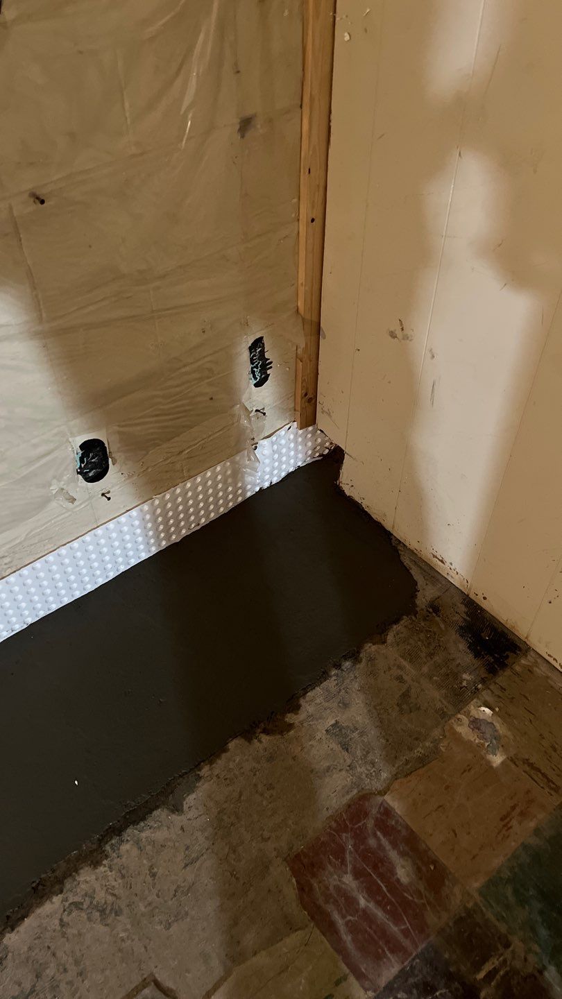 Interior drain tile system installation by ACE Waterproofing & Basement Solutions