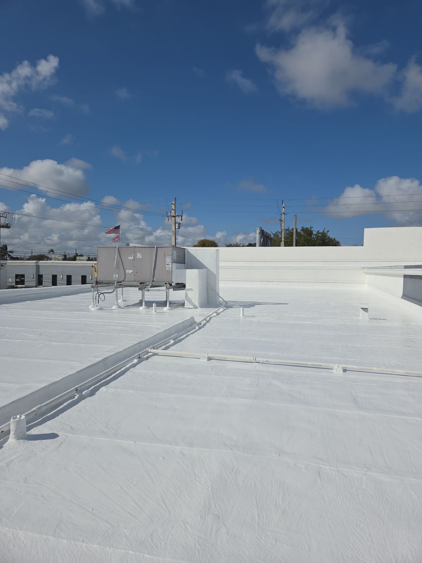 Commercial Flat Roof Restoration Using Silicone Coating in Hallandale Beach by Aastro Roofing