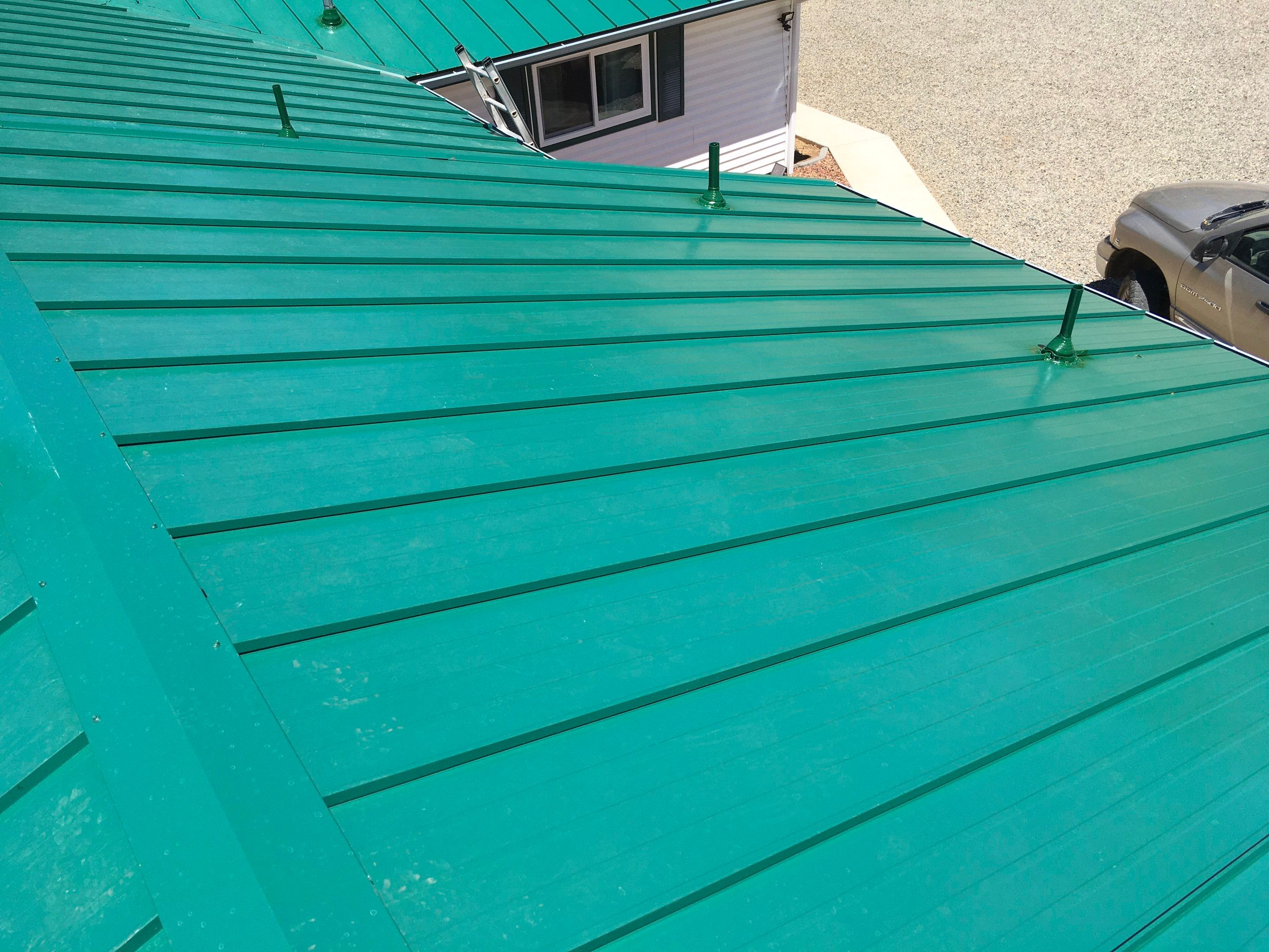 Metal roofing installation using Standing seam metal roofing system by Straight Edge Roofing Inc