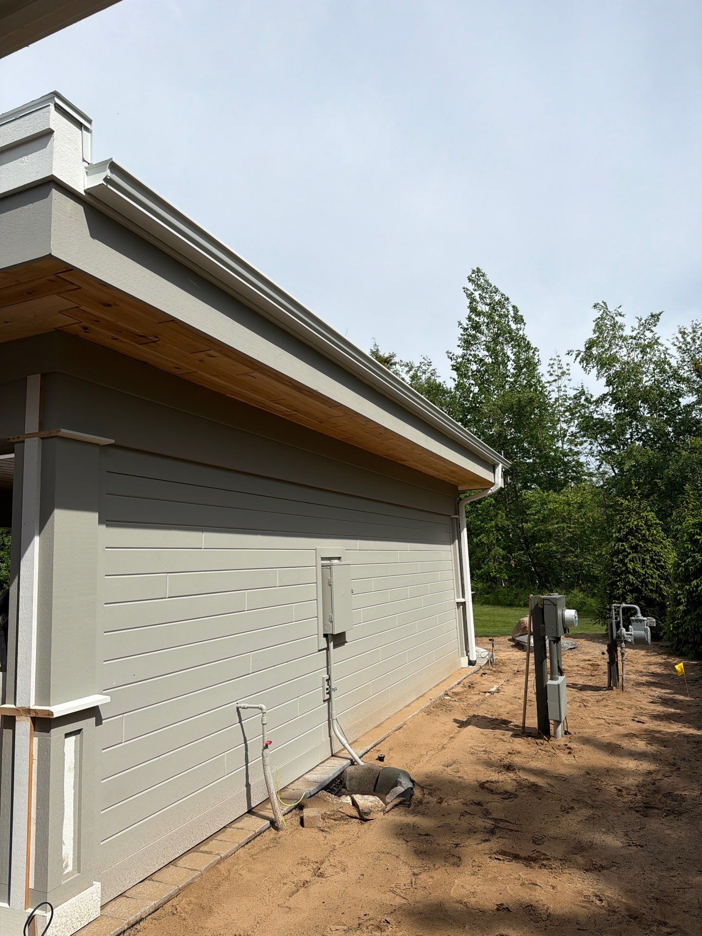 White Gutter and Downspout Installation for a Petoskey Home by Rainbow Seamless Systems