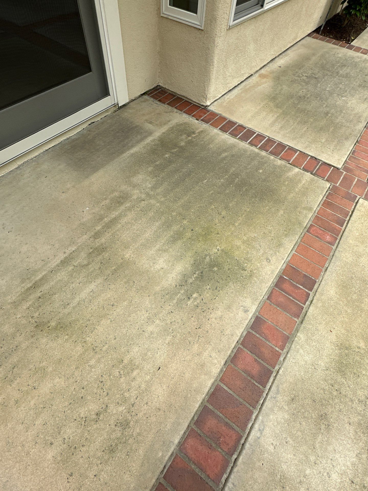 Surface cleaning pressure washing in Orange County on patio, walkways, and driveway by Property Cleaning Experts, LLC