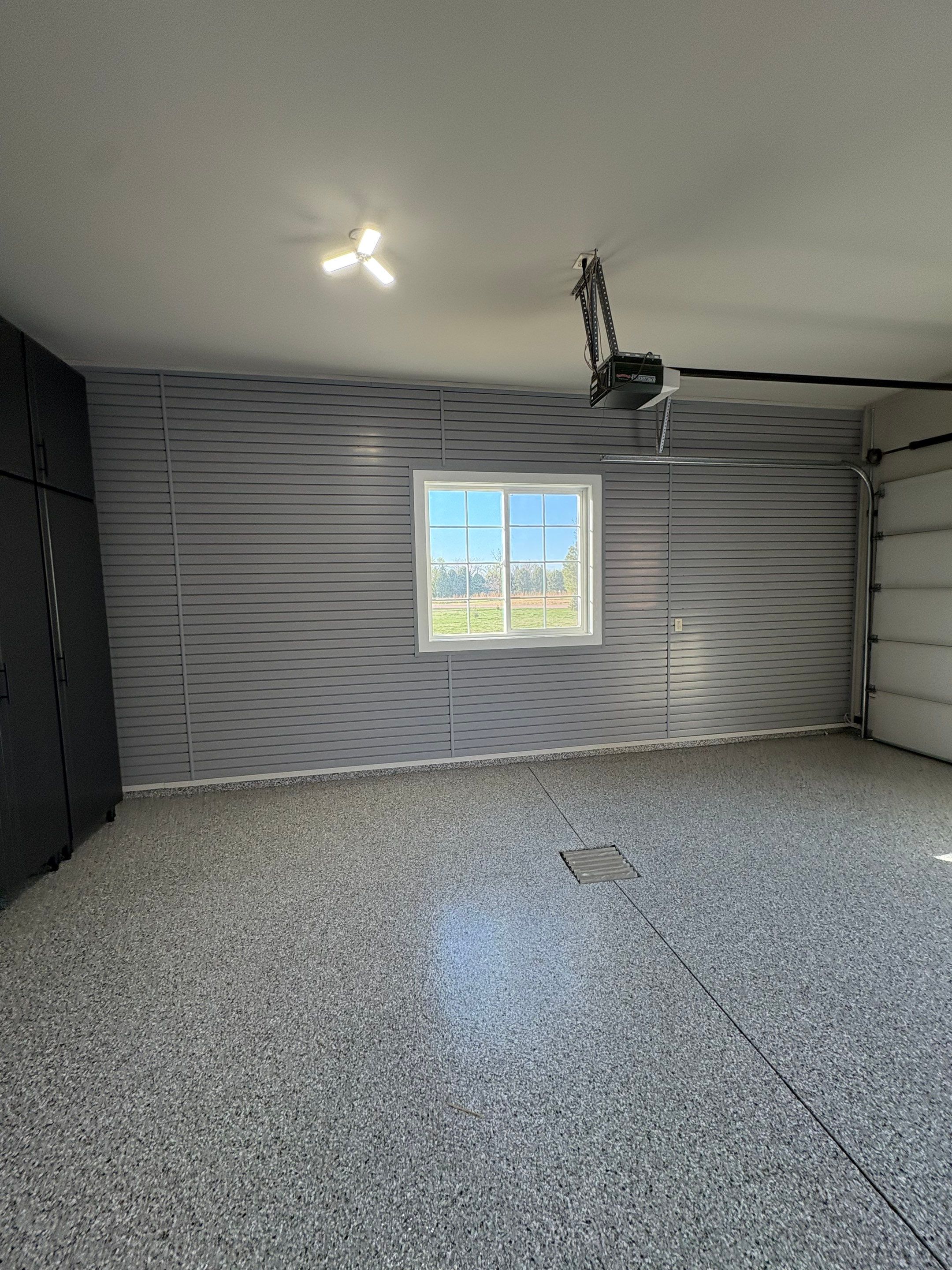 Yankton Garage Transformation with Dark Storage Cabinetry and Epoxy Flooring by Select Painting, Coatings & Garage Cabinets