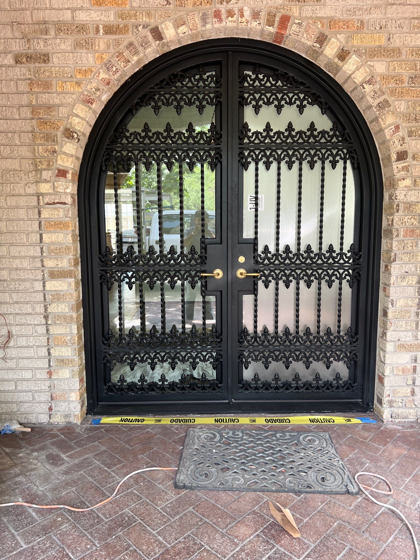 Custom Arched Black Wrought Iron Double Door Installation in Dallas by Solara Custom Living