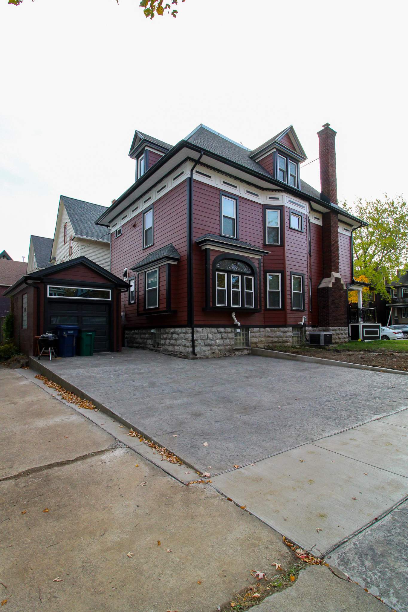Exterior Renovations- Siding, Stamped Concrete, Porch, and Railings by Ivy Lea Construction
