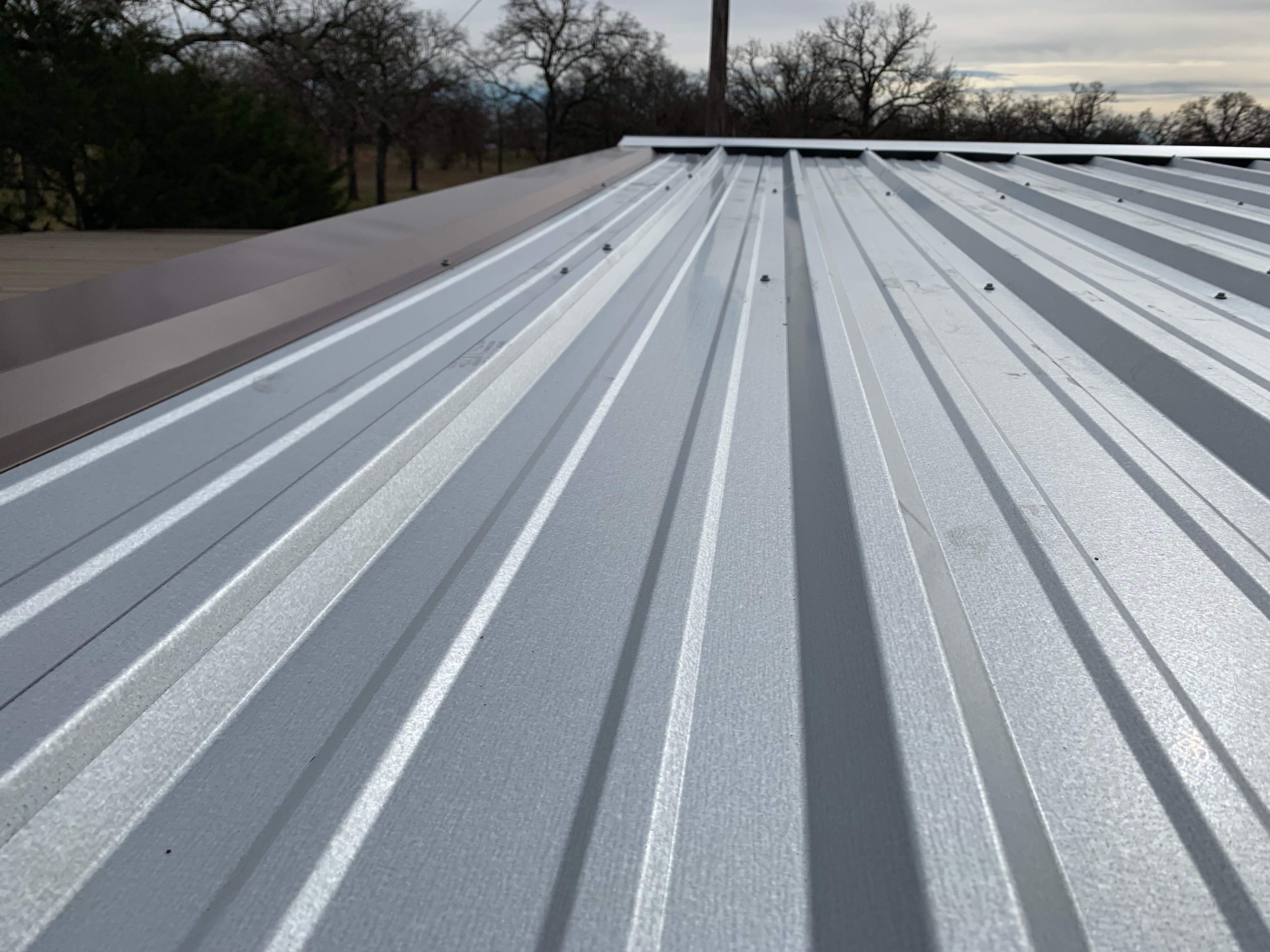 Install new R Panel Metal Roof at a Clients Farm house by First United Roofing & Construction