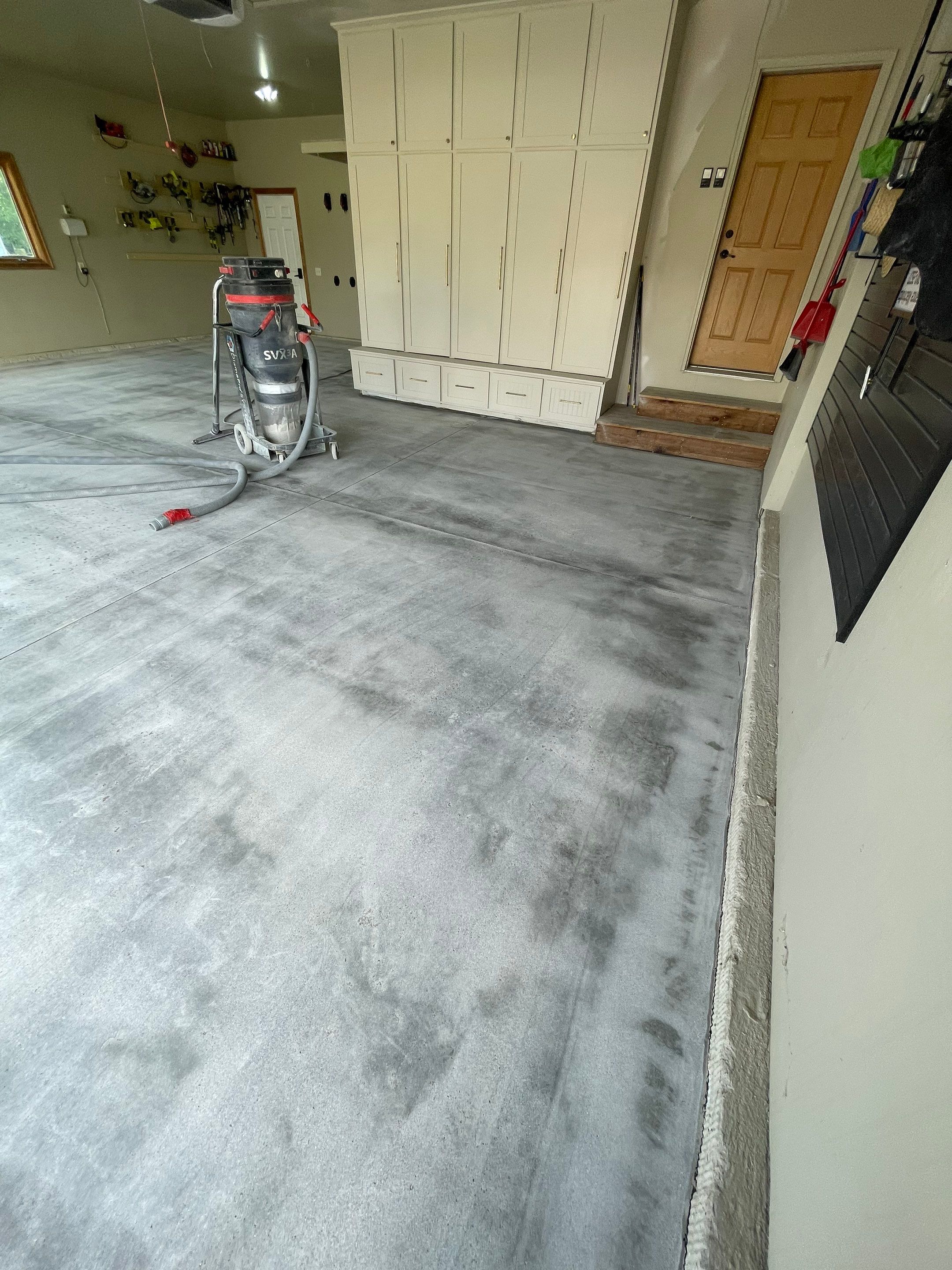 Cabin FEver Flake Garage Floor Coating Installation in Sioux Falls by Select Painting, Coatings & Garage Cabinets