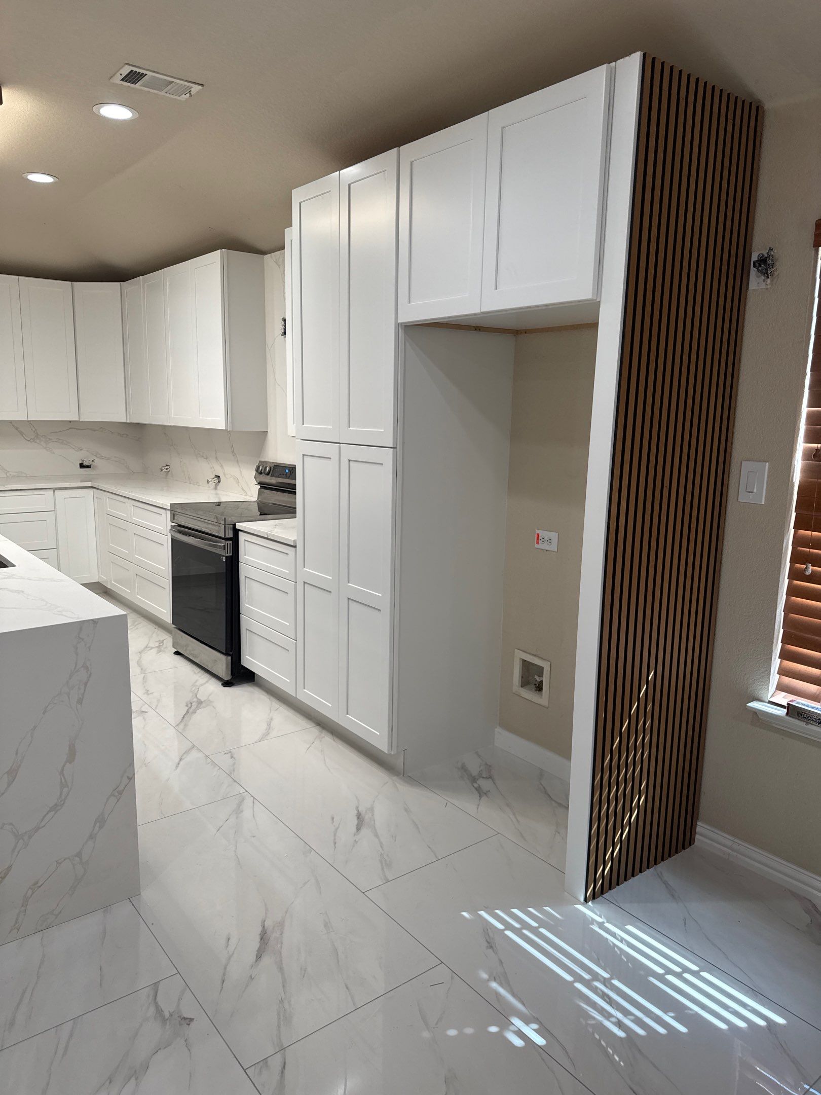 Luxury Focal Point: Full Kitchen Remodel with Double Waterfall Island by Tibi Soli LLC