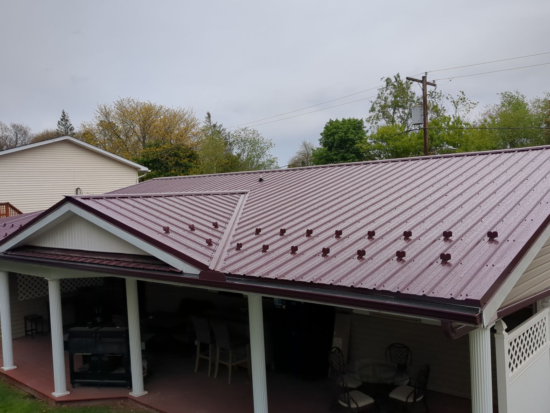 Maroon ABM Metal Roof Replacement and Gutter Installation in Shenandoah by Esh Builders