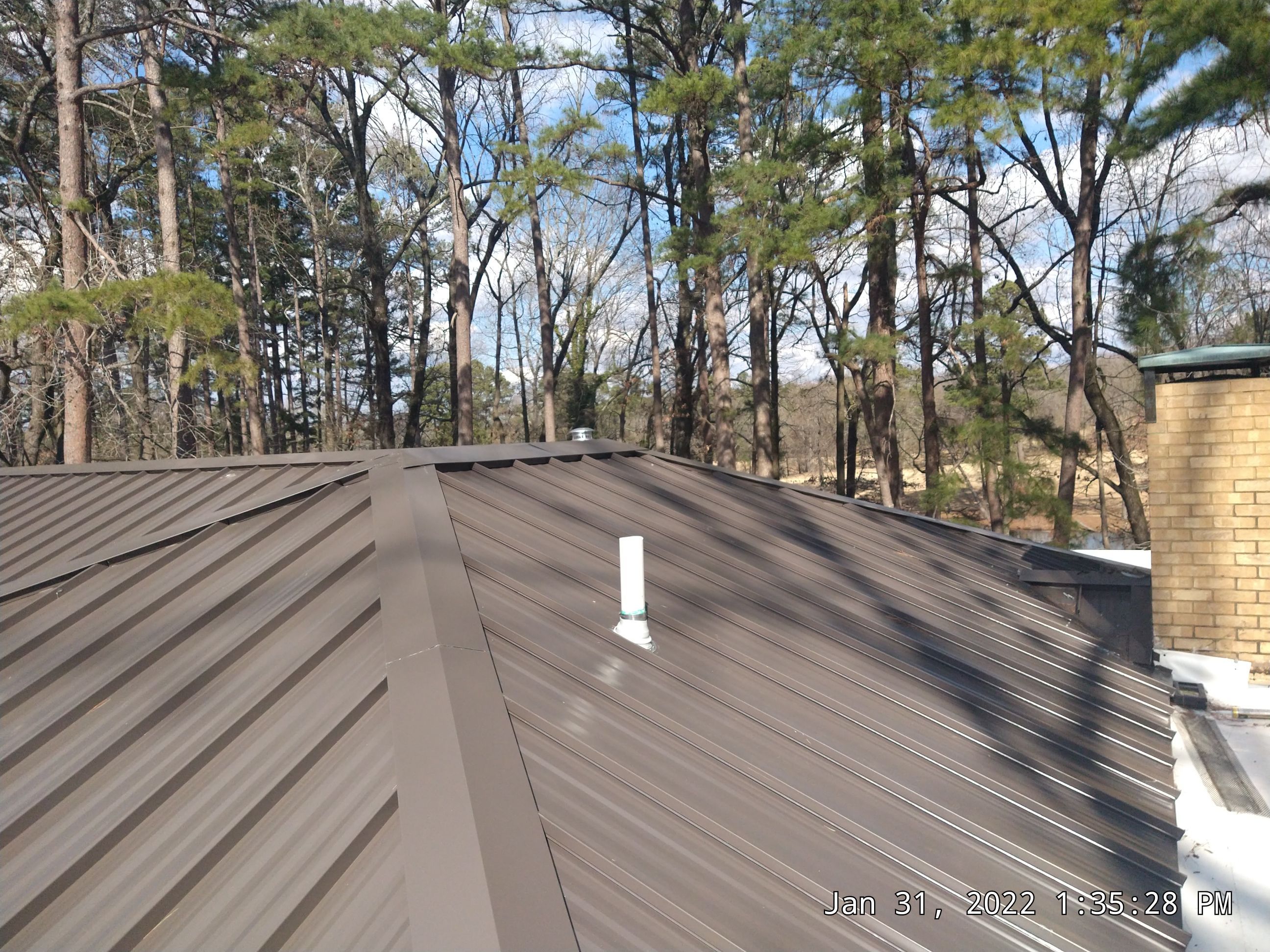 Residential Roofing Installation using PVC membrane and 24 gauge Standing Seam Metal by Hostetler Roofing